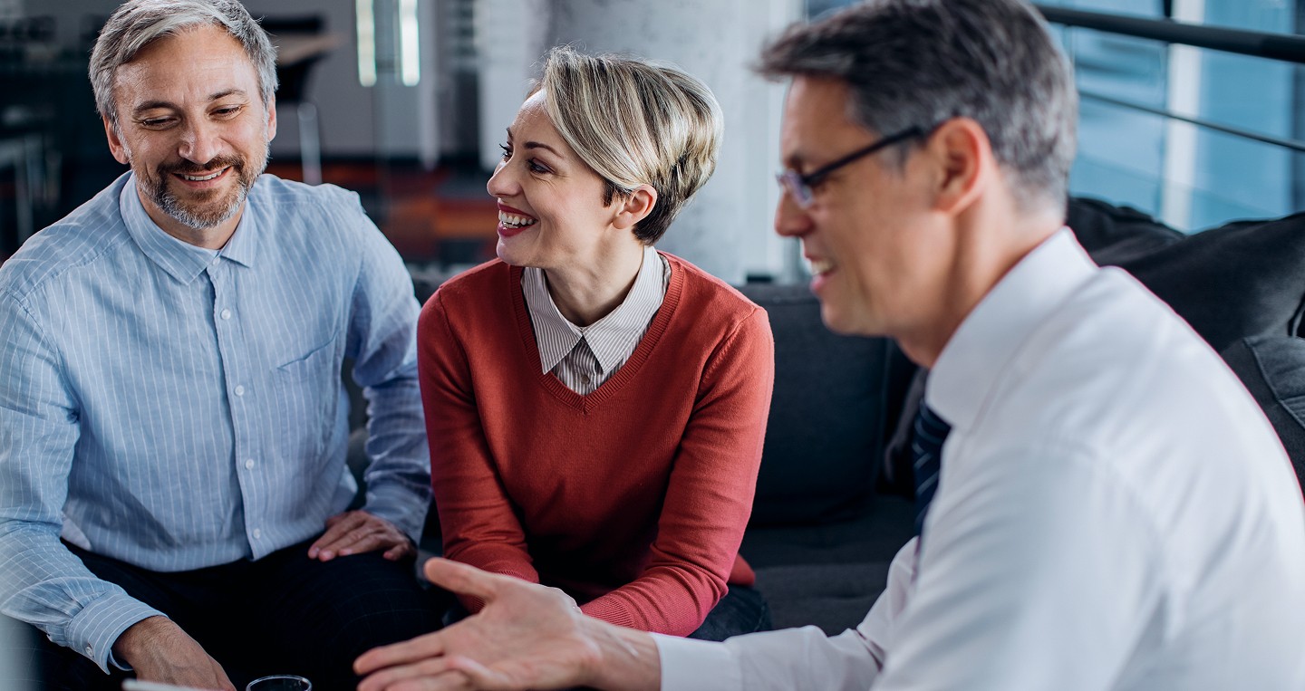 Couple discussing their financial plans with an adviser