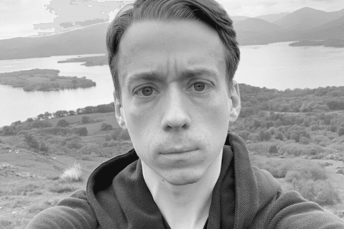 Scott in front of a lake and some mountains