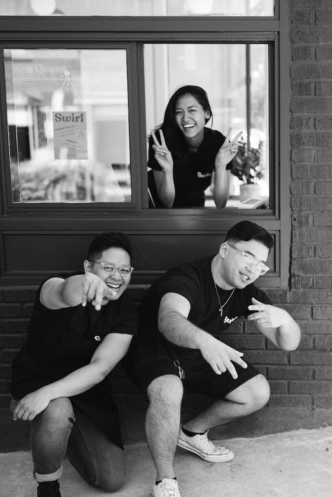 man with glasses smiling fully 