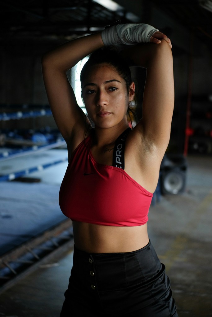 a woman in a red top and black skirt