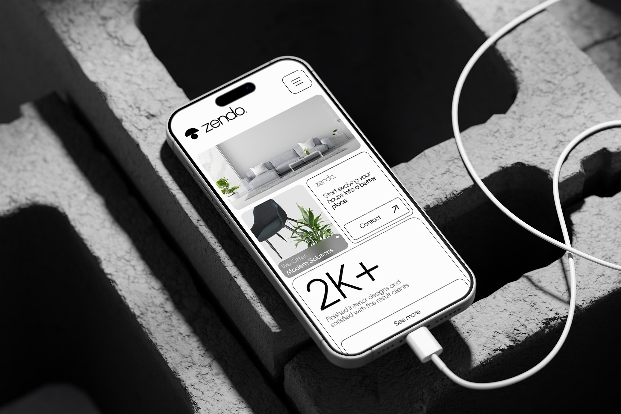 Phone on concrete bricks, website on screen