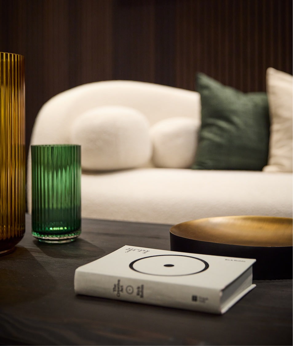 Coffee table in Biograph New York private suite featuring Outlive by Peter Attia, reflecting the clinic’s longevity-focused design.