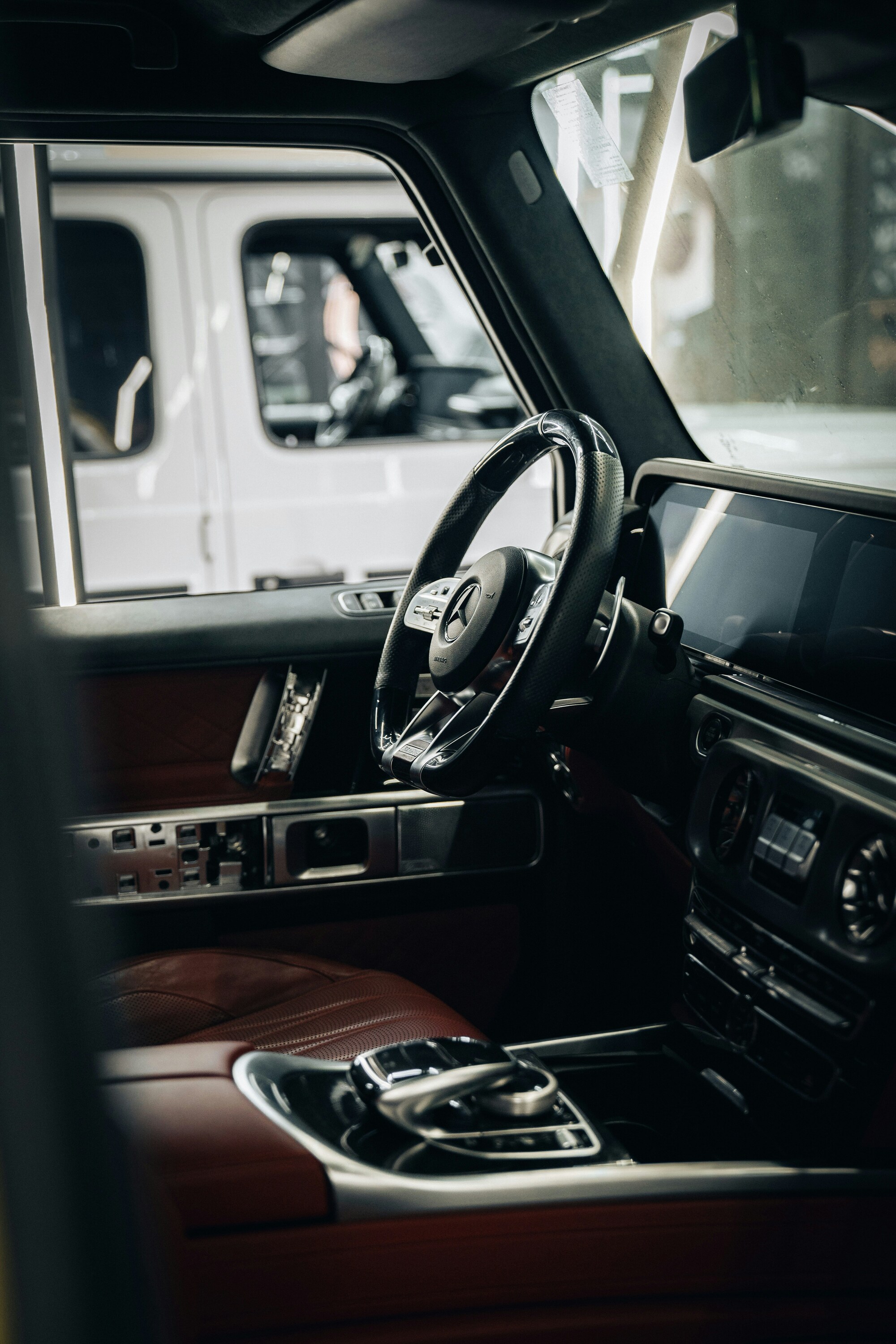 The interior of a car with a steering wheel and dashboard