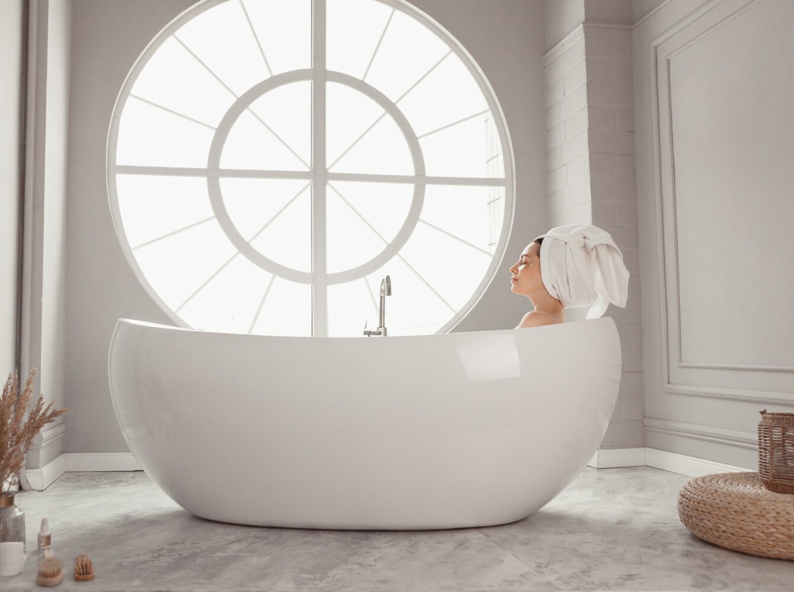 young woman enjoying the benefits of Epsom salt baths by relaxing in a bath she prepared