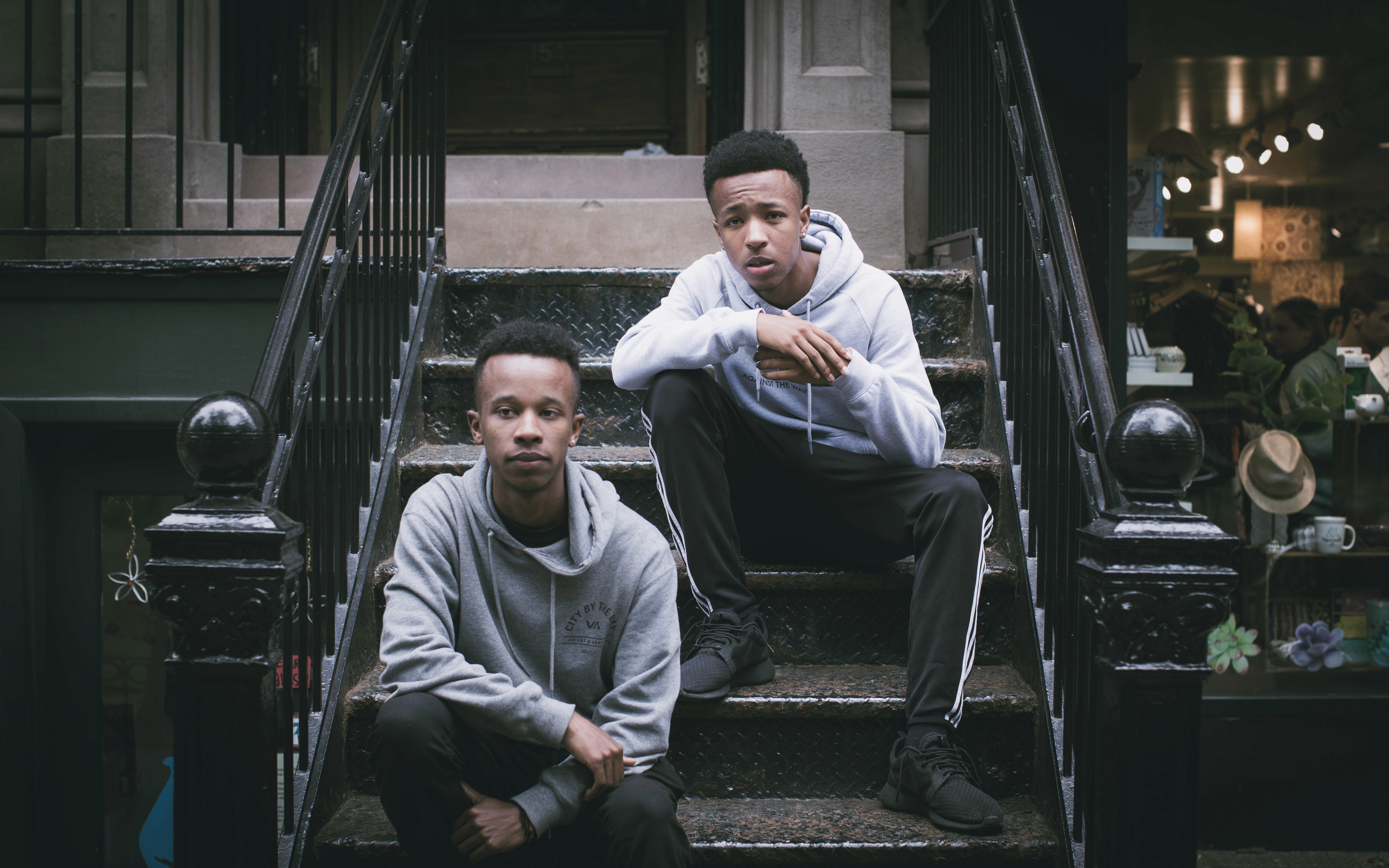 Brother sitting on stairs in NYC