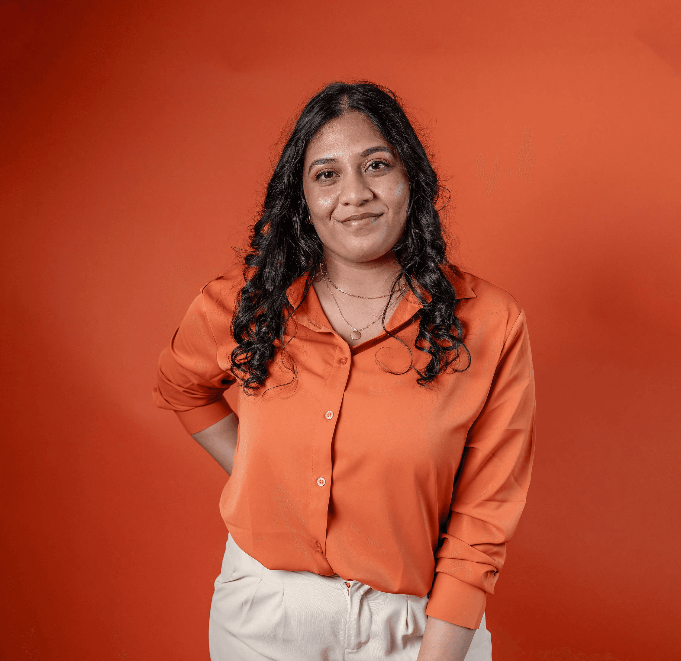 A thoughtful young person with dark hair gazes to the side, captured in soft black and white lighting.