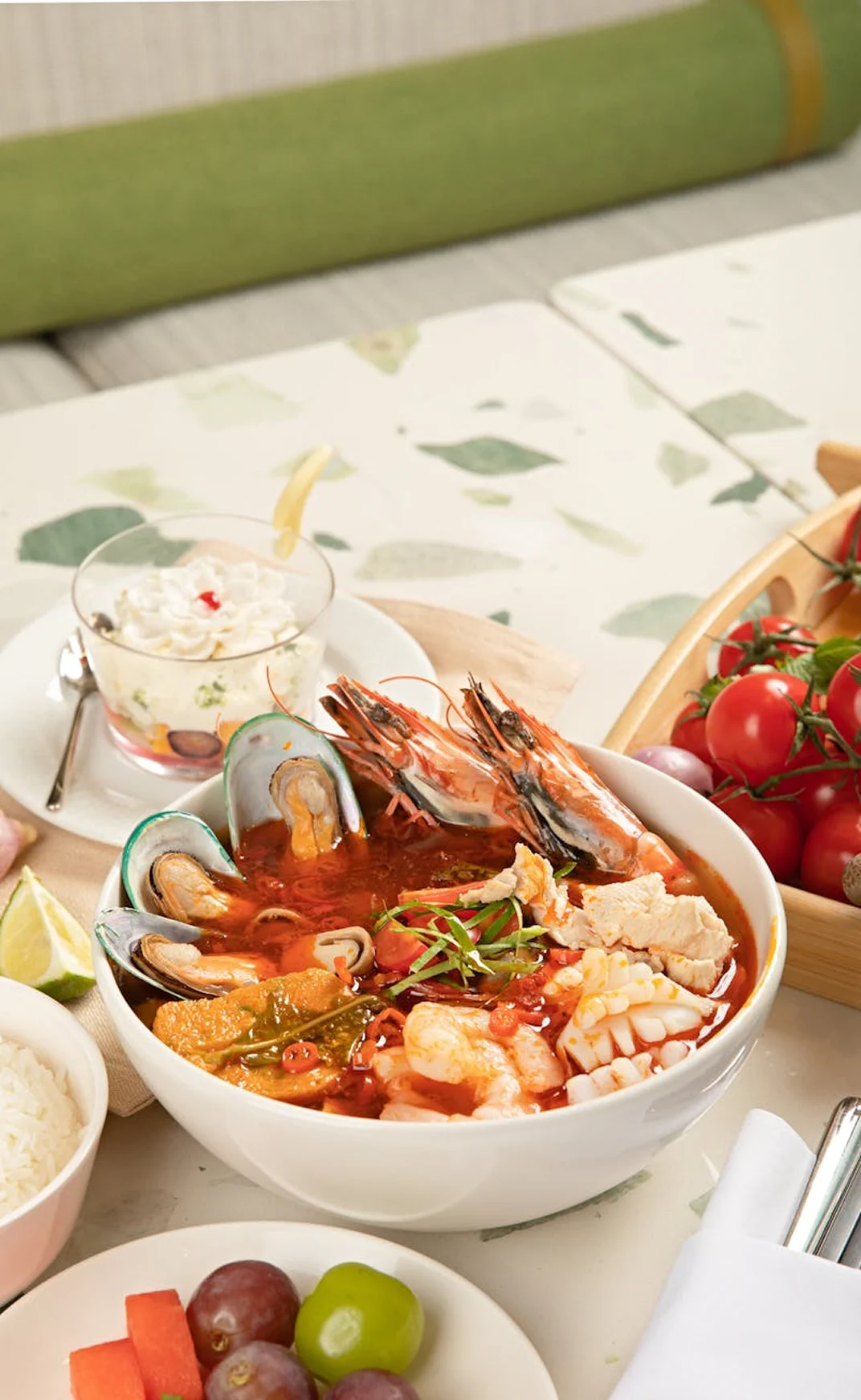 Seafood meal with prawns, vegetables, and fresh side dishes served on a bright dining table.