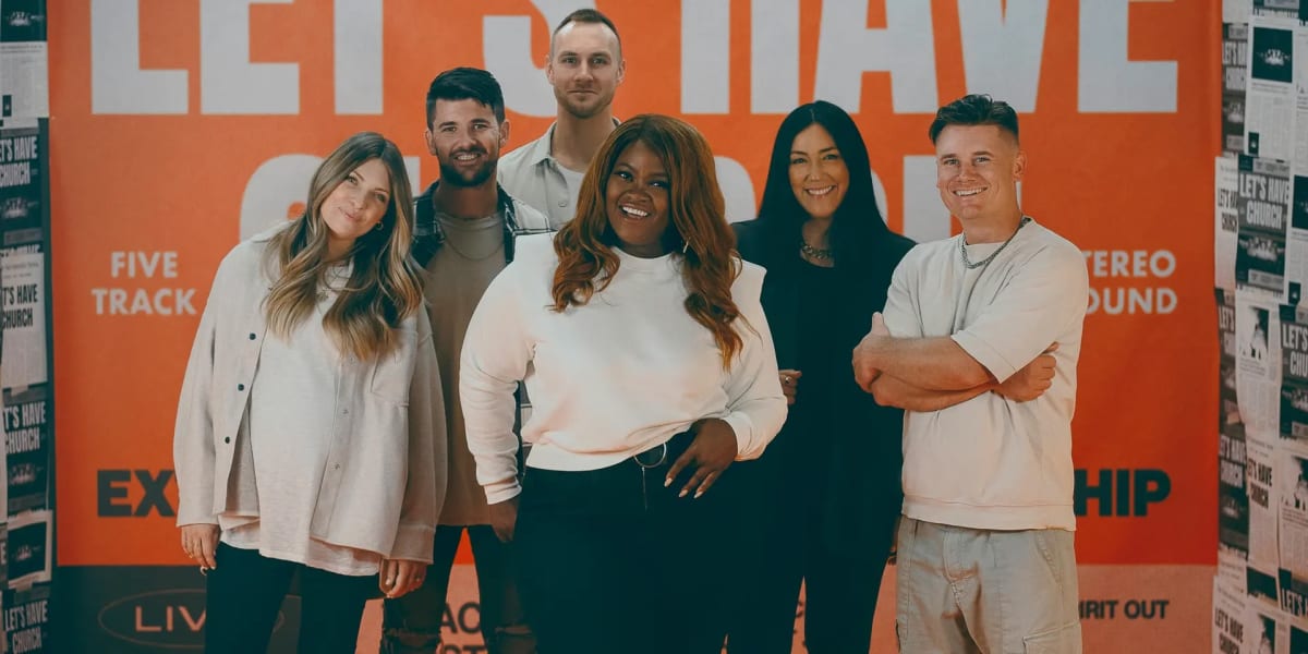 Cover image for the free MxU worship ministry resource titled 'Free Worship Multitracks': six people smiling in front of an orange and white wall.