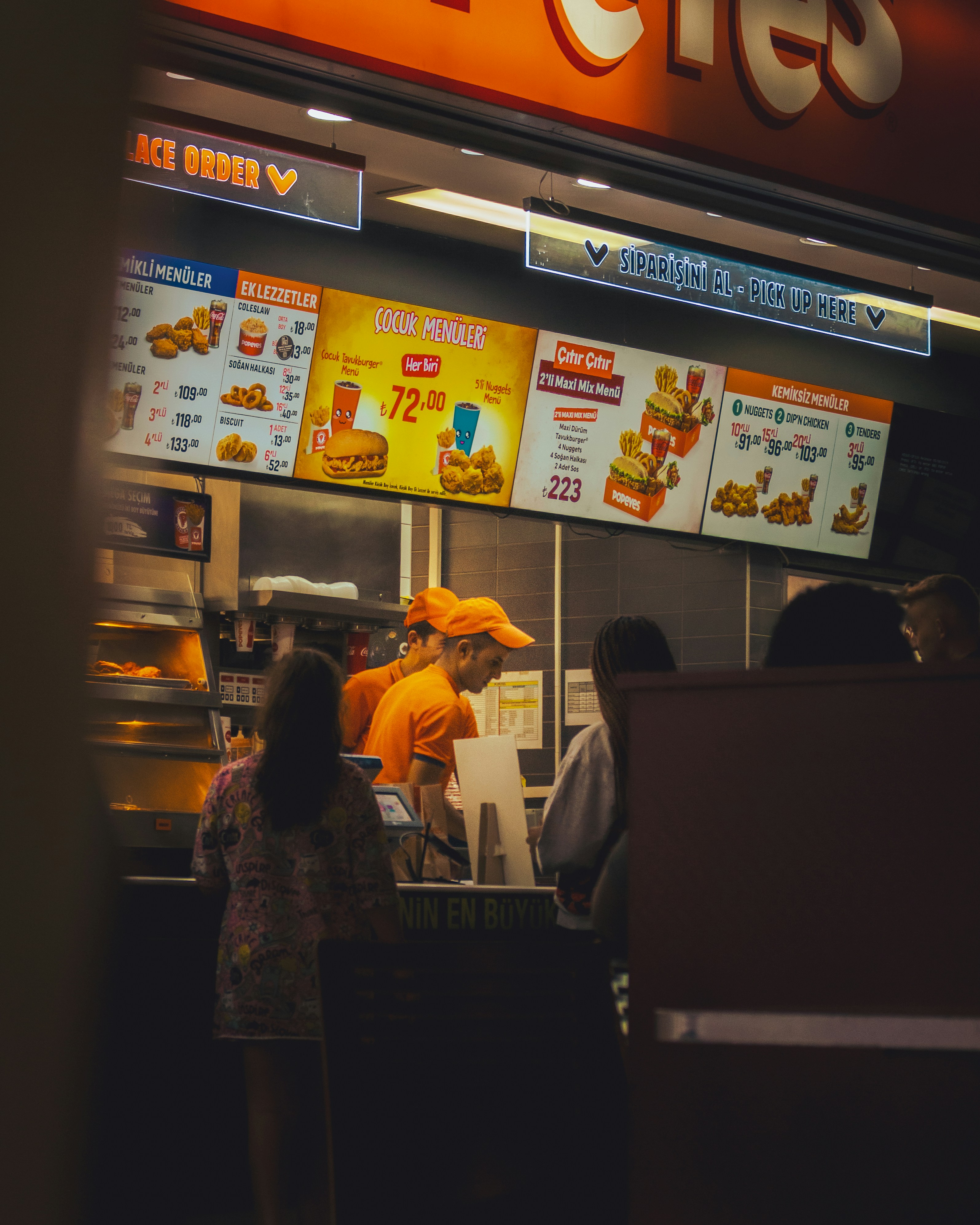 A fast food restaurant with people ordering food