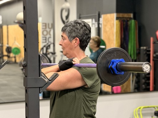 group of women exercise using dumbbells