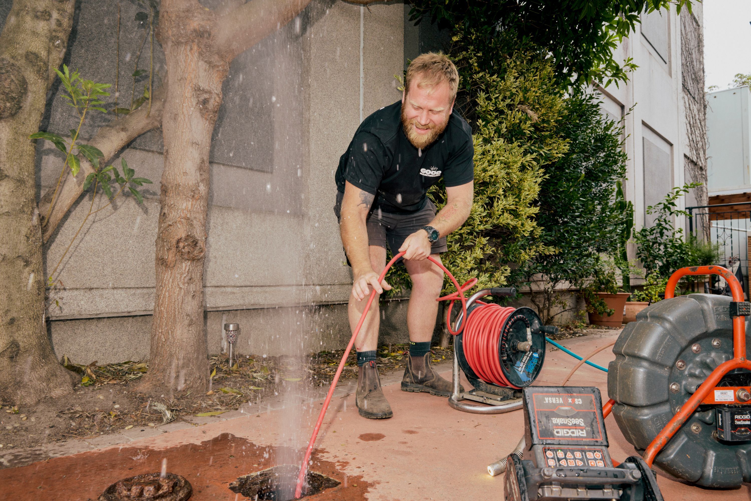 Good Maintenance plumber clearing a blocked drain using professional equipment at a Melbourne home.