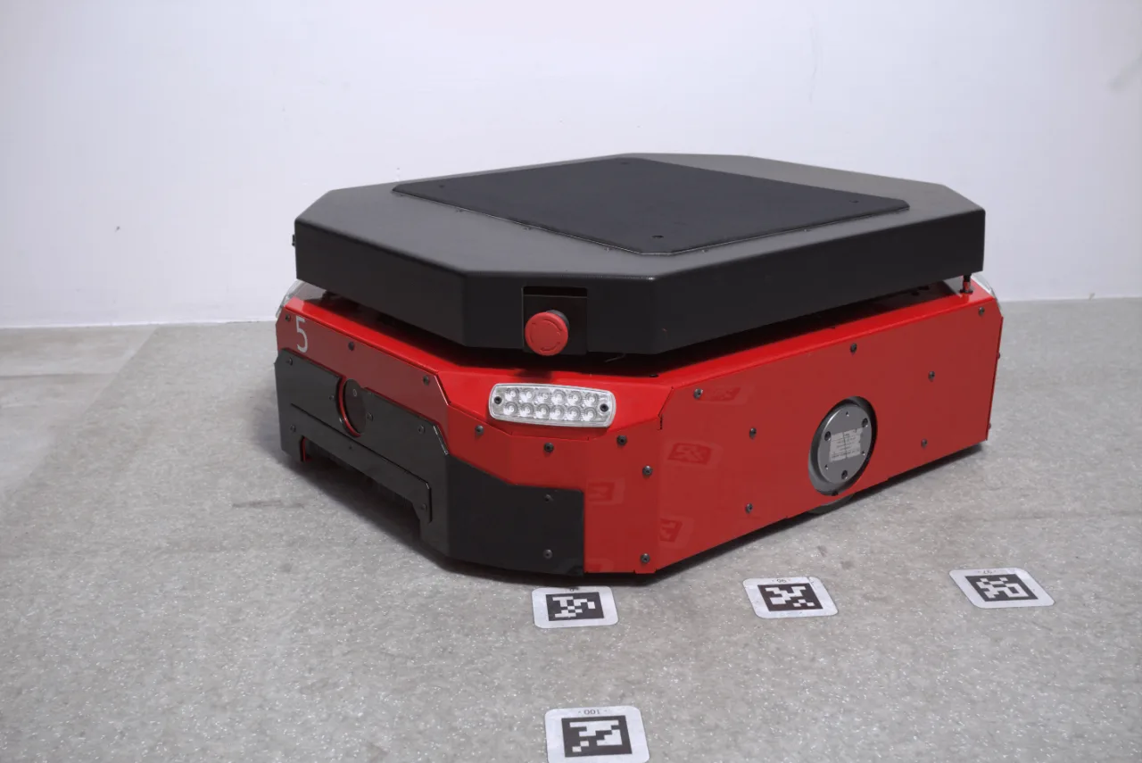 A red and black suitcase sitting on top of a carpet