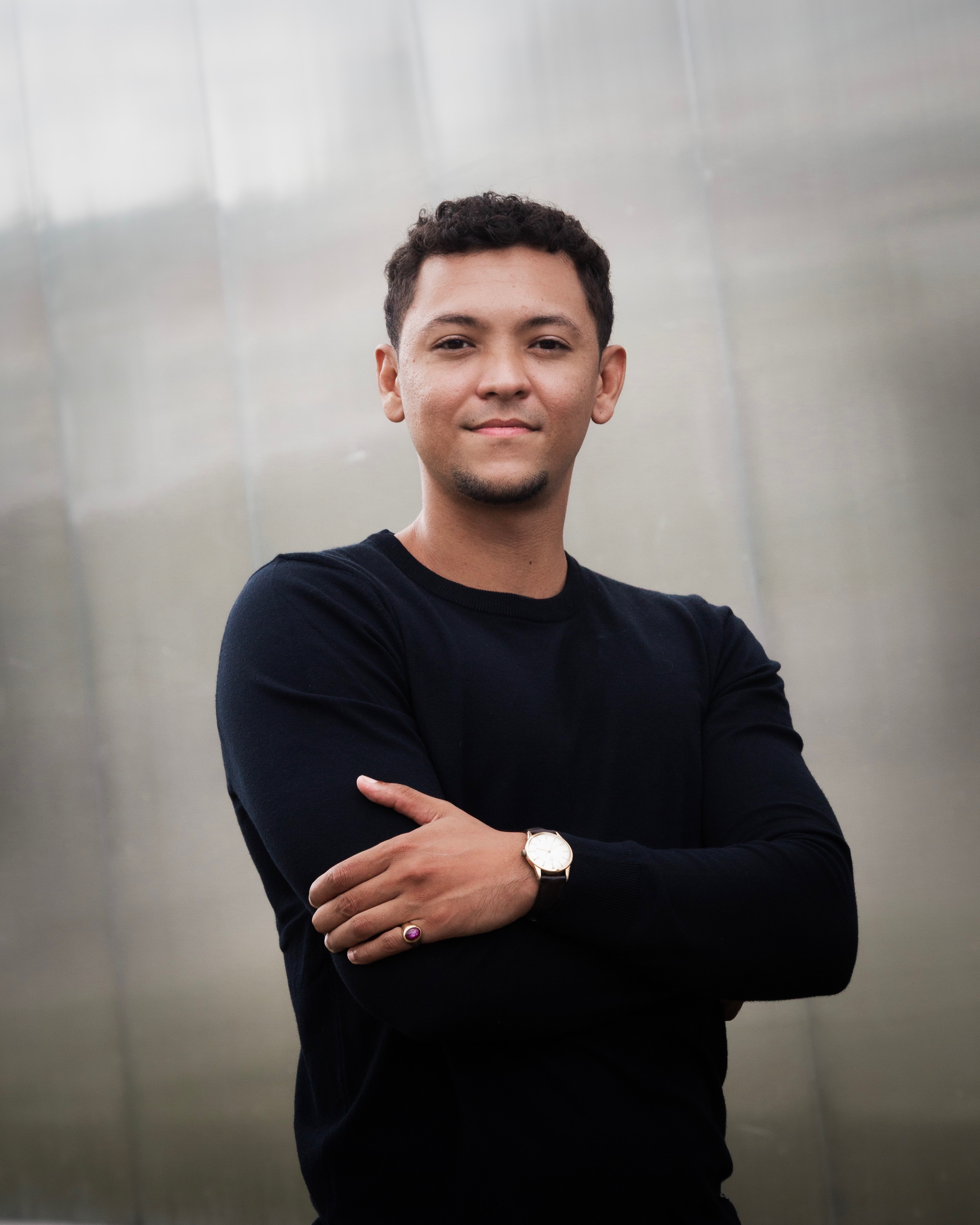 Profile portrait of a man in a white shirt against a light background