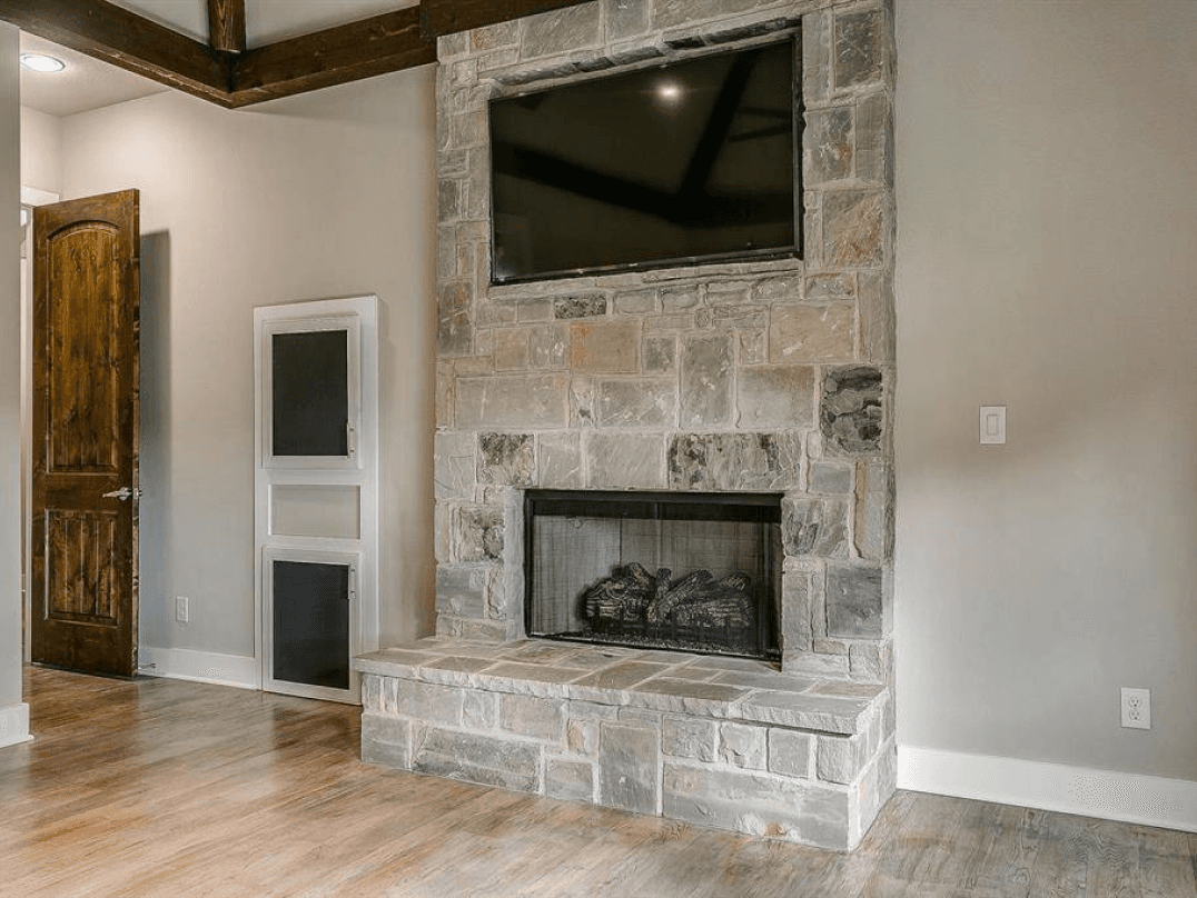 Stacked stone gas fireplace in the primary suite