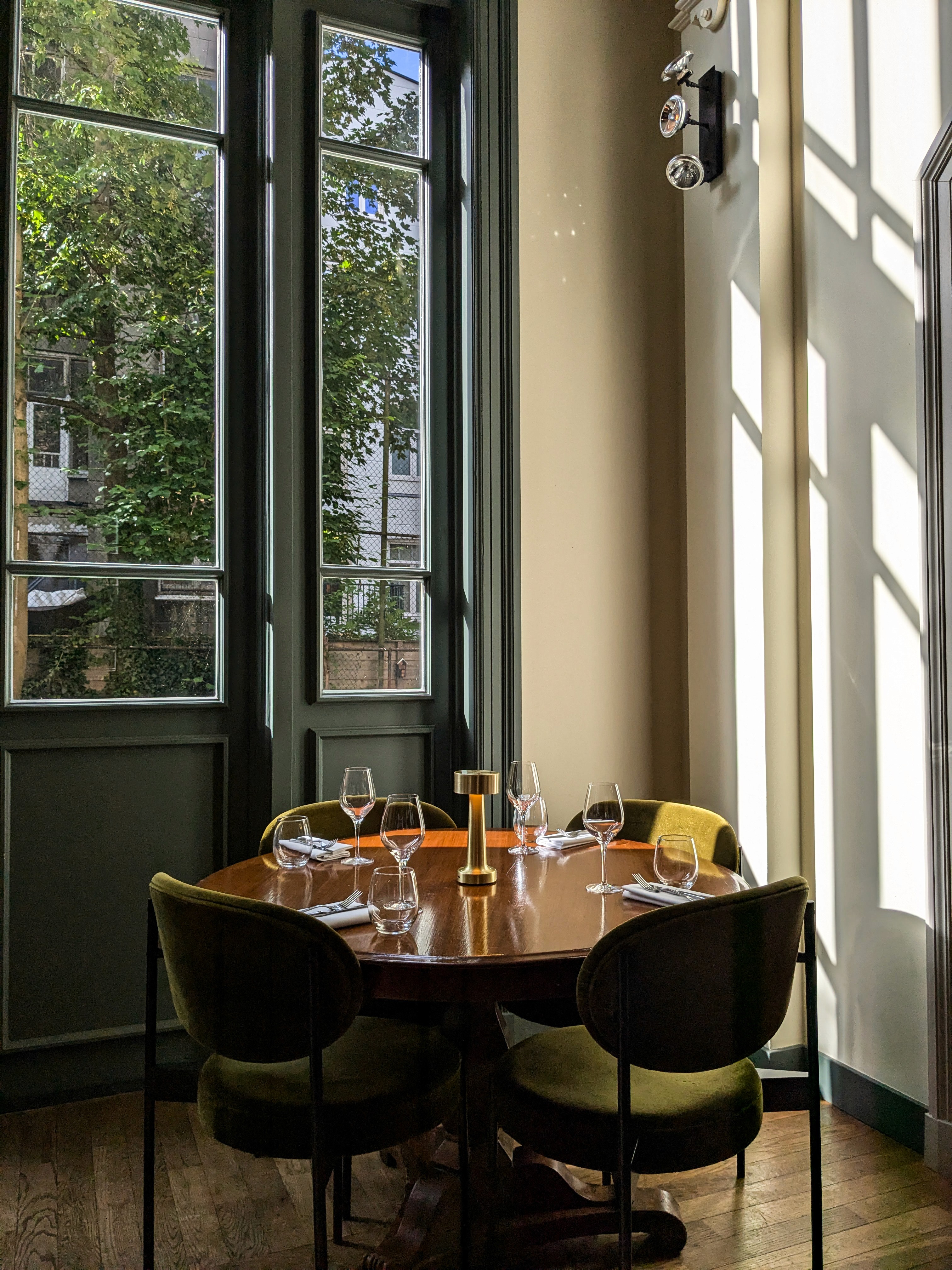 Lamplit dining room with tall windows