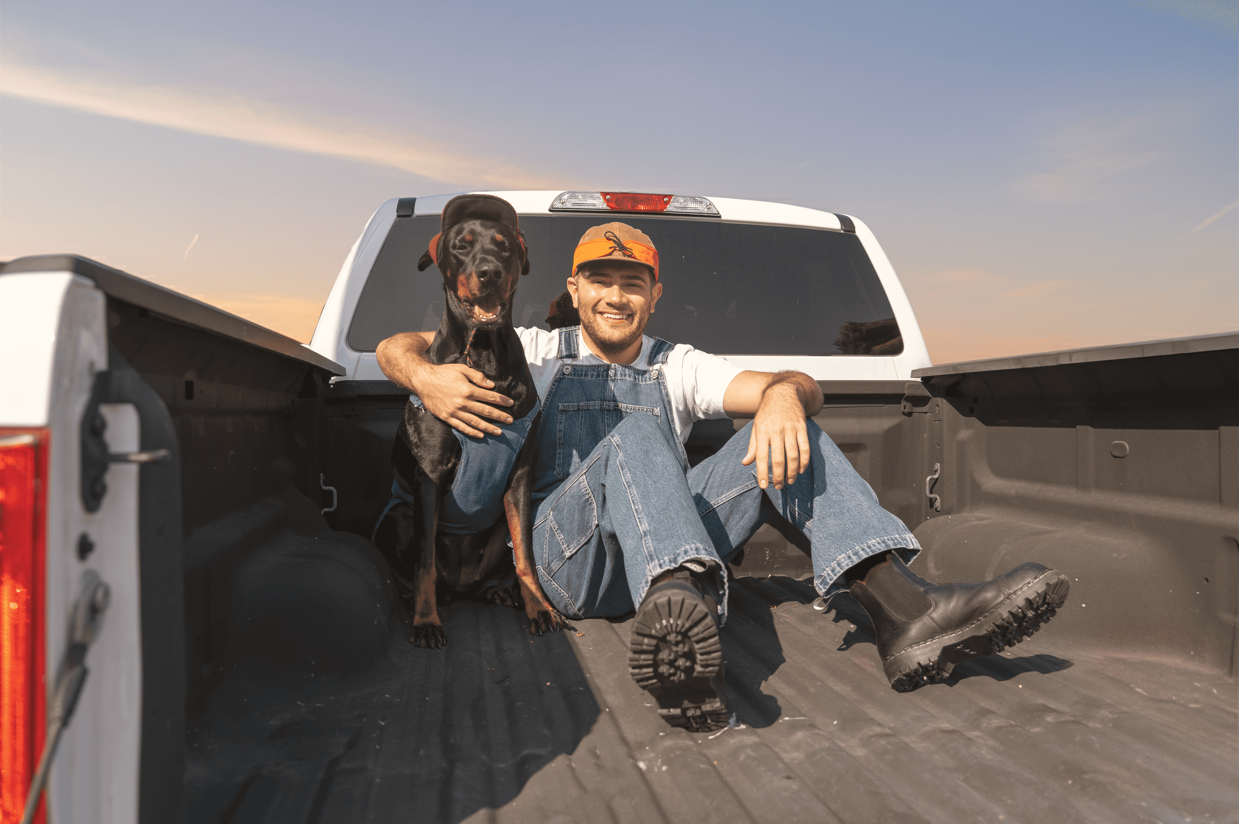 Tree branches reach towards a clear, blue sky.