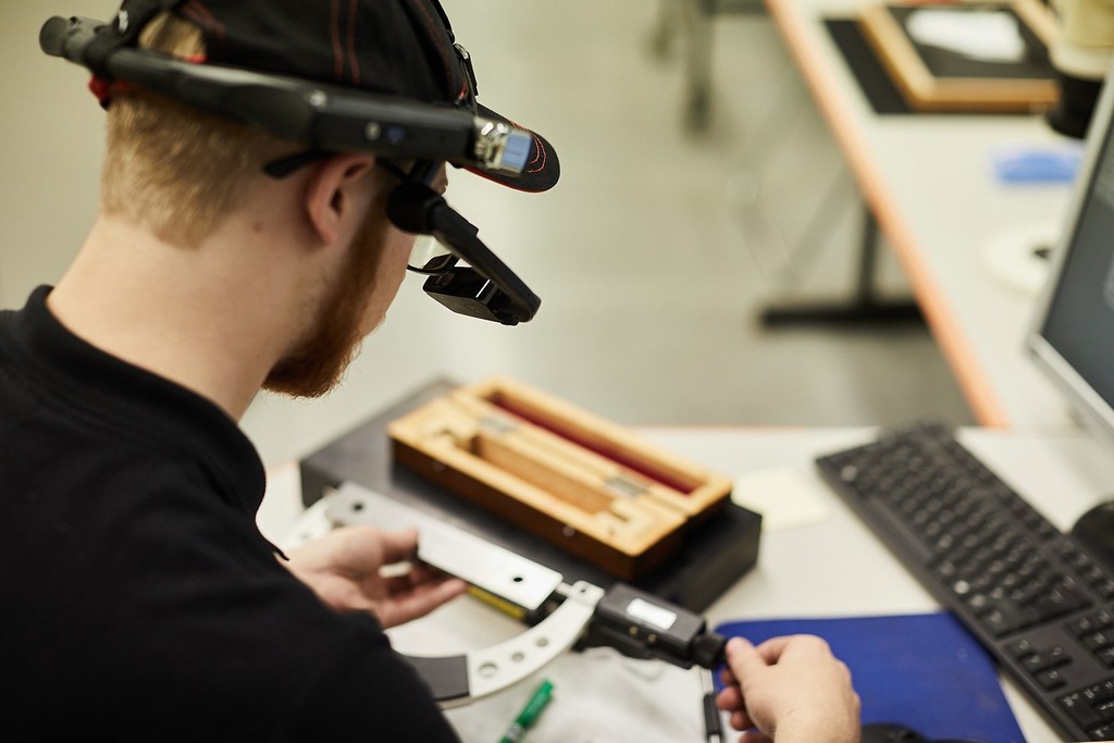 An industrial worker wearing a RealWear headset