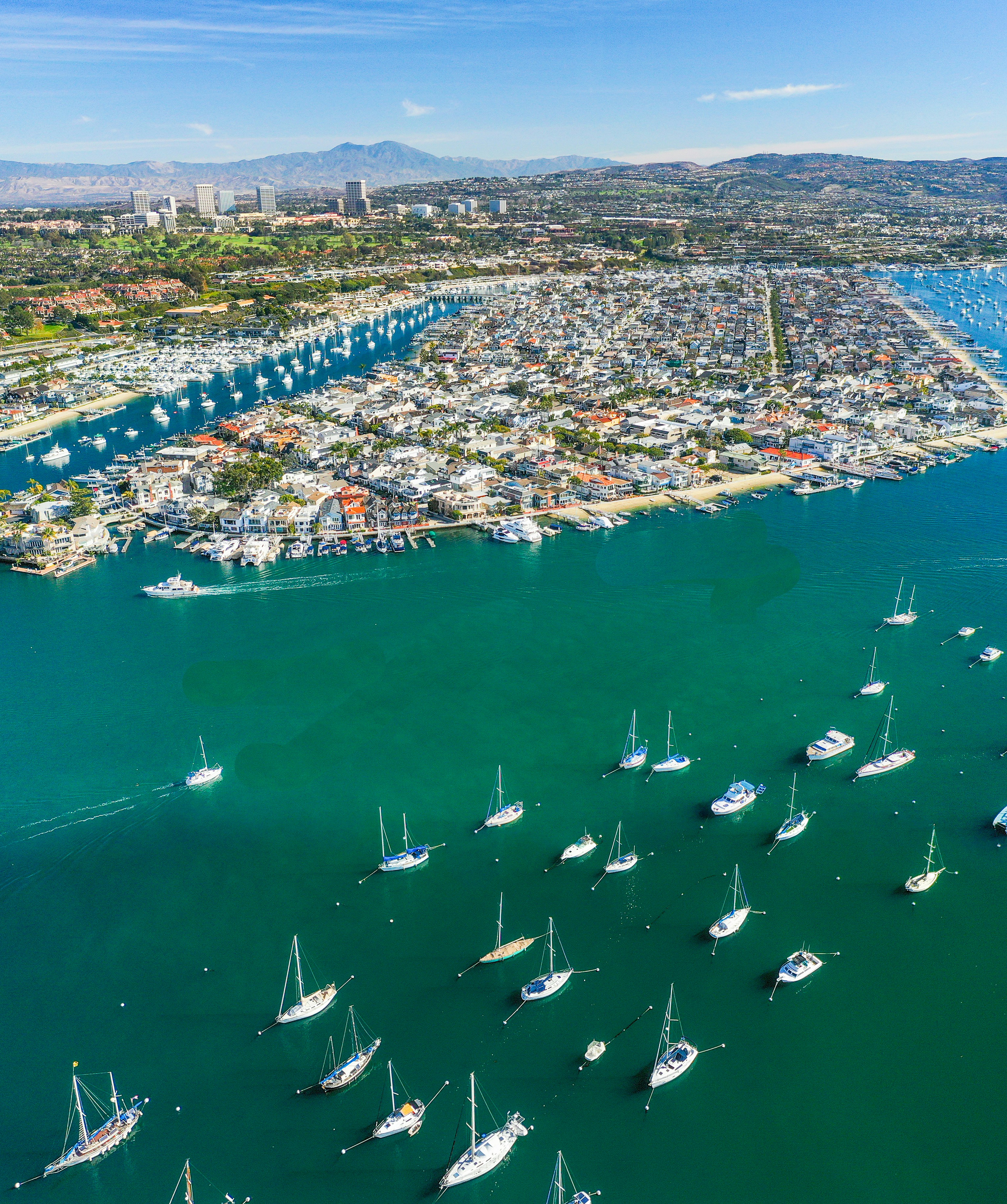 a body of water with boats in it and a city in the background