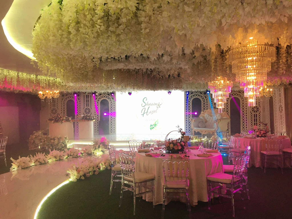 Company celebration staging with LED wall in soft pink light at Celestia Hall, Stalla Suites QC