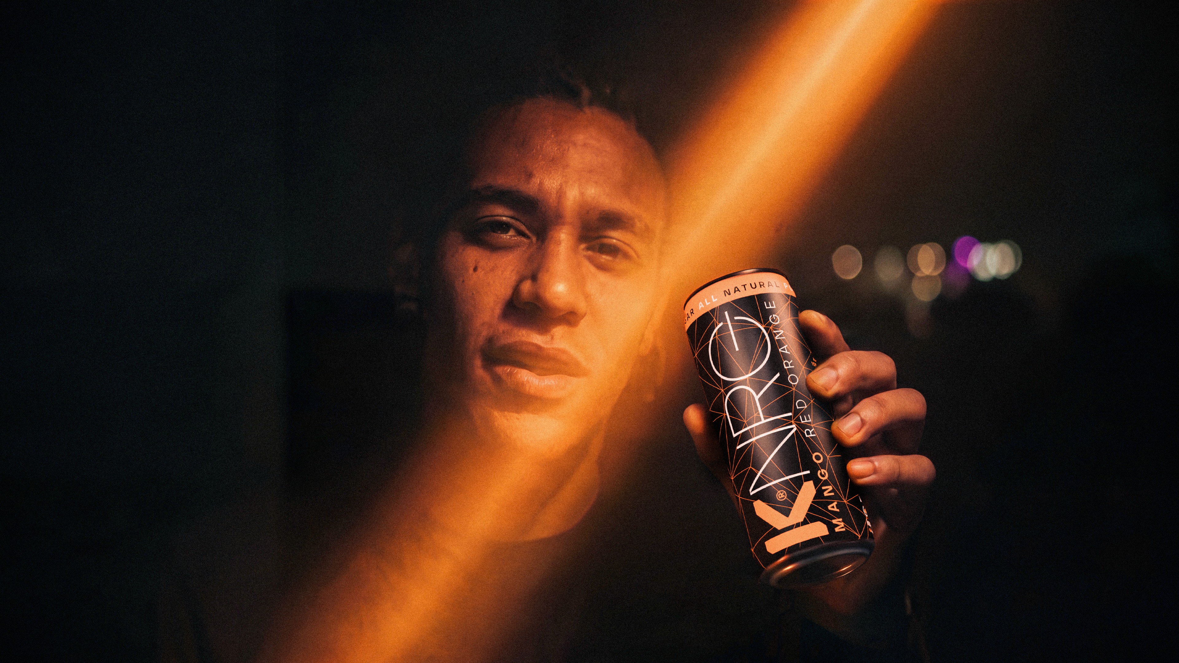 KNRG portrait with a mango can and orange light.