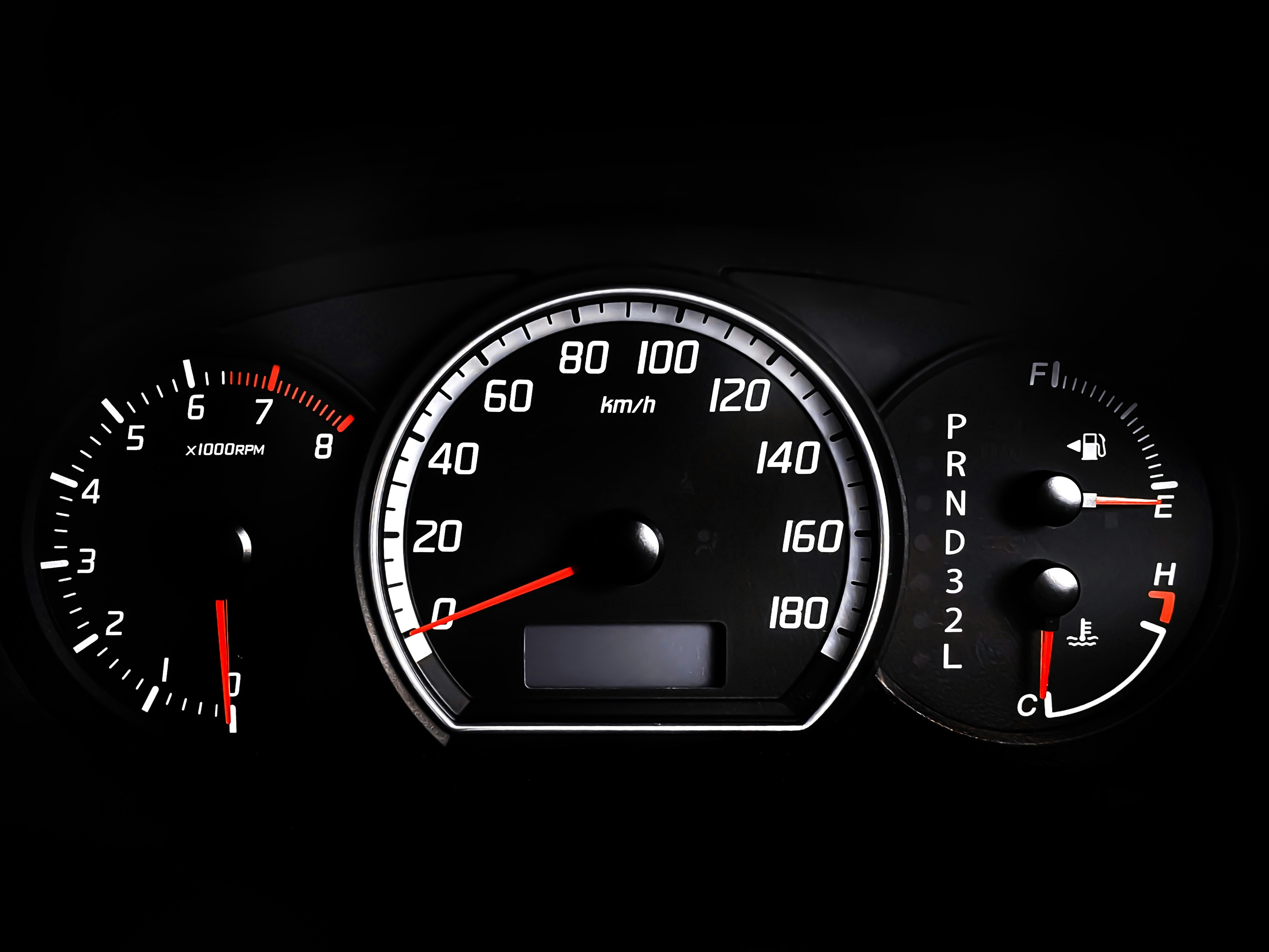 Car dashboard close-up showing the instrument cluster and odometer area