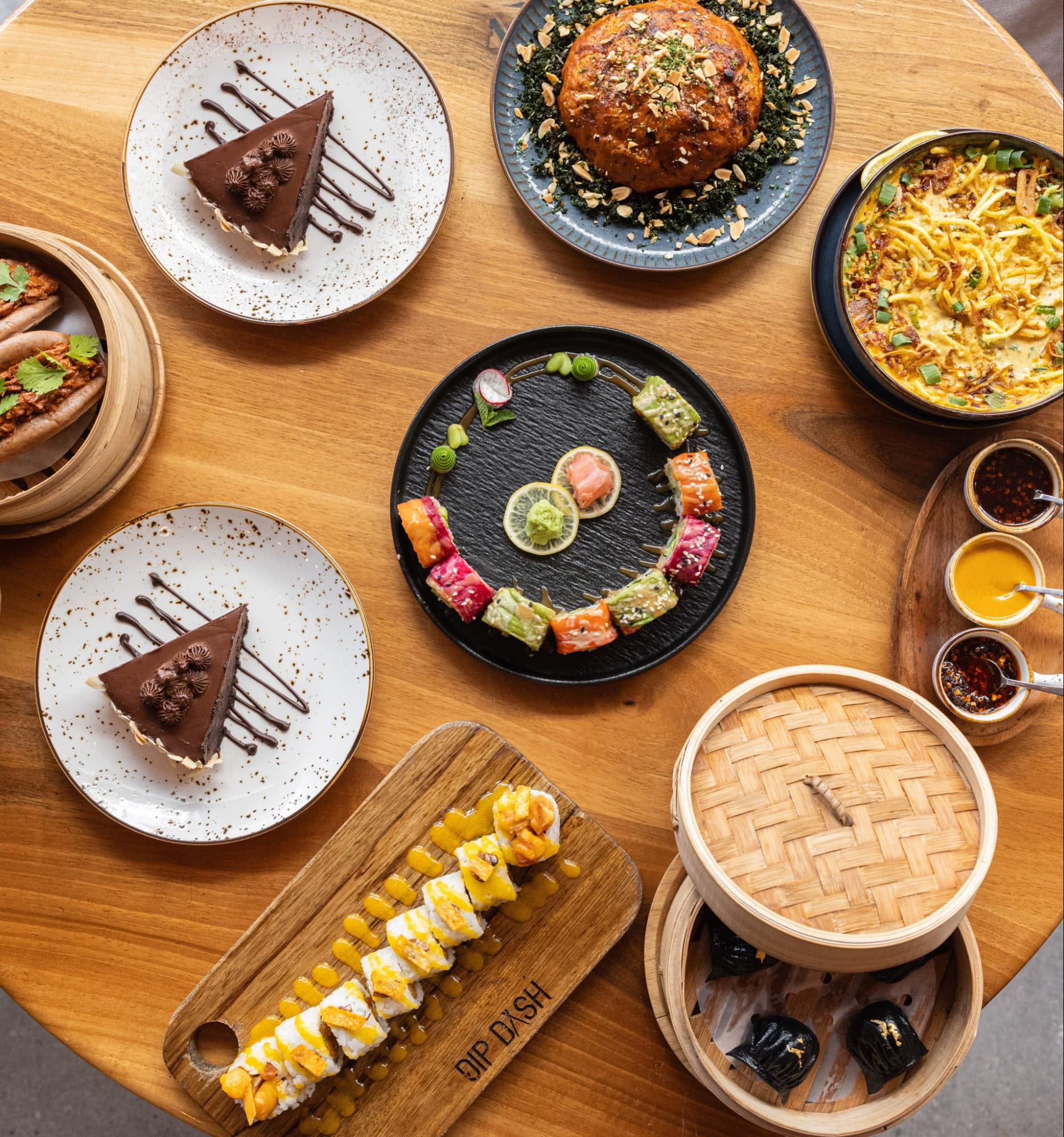 Vegan food featuring multiple colourful plant-based dishes, shared plates, vibrant textures, and bold flavours on a lively table.