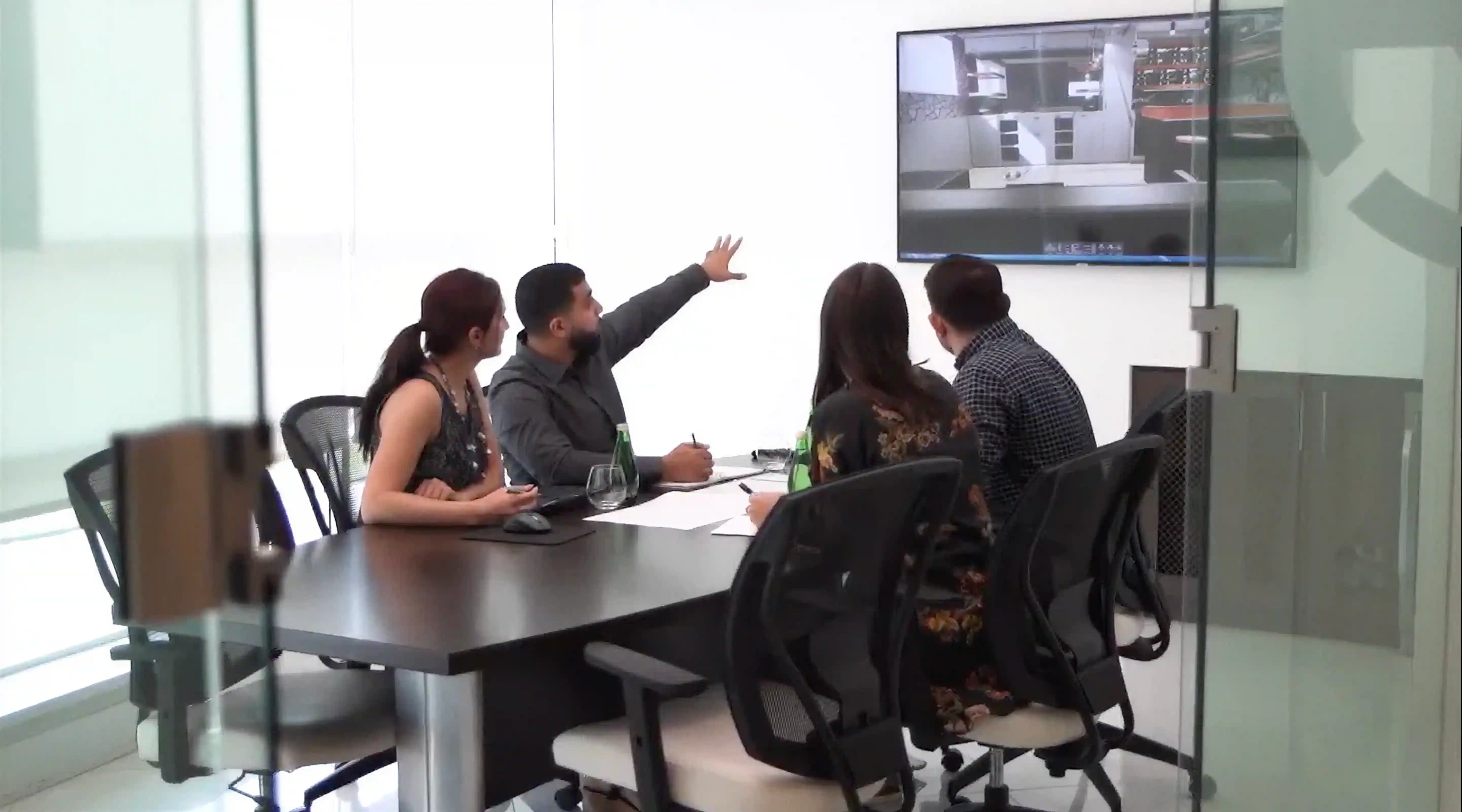 Custom home project team reviewing plans and construction details during a fixed price planning meeting