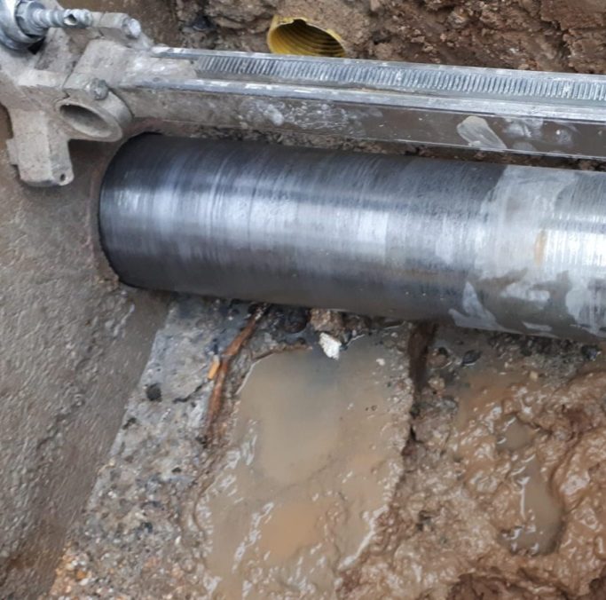 woman sitting around table holding tablet