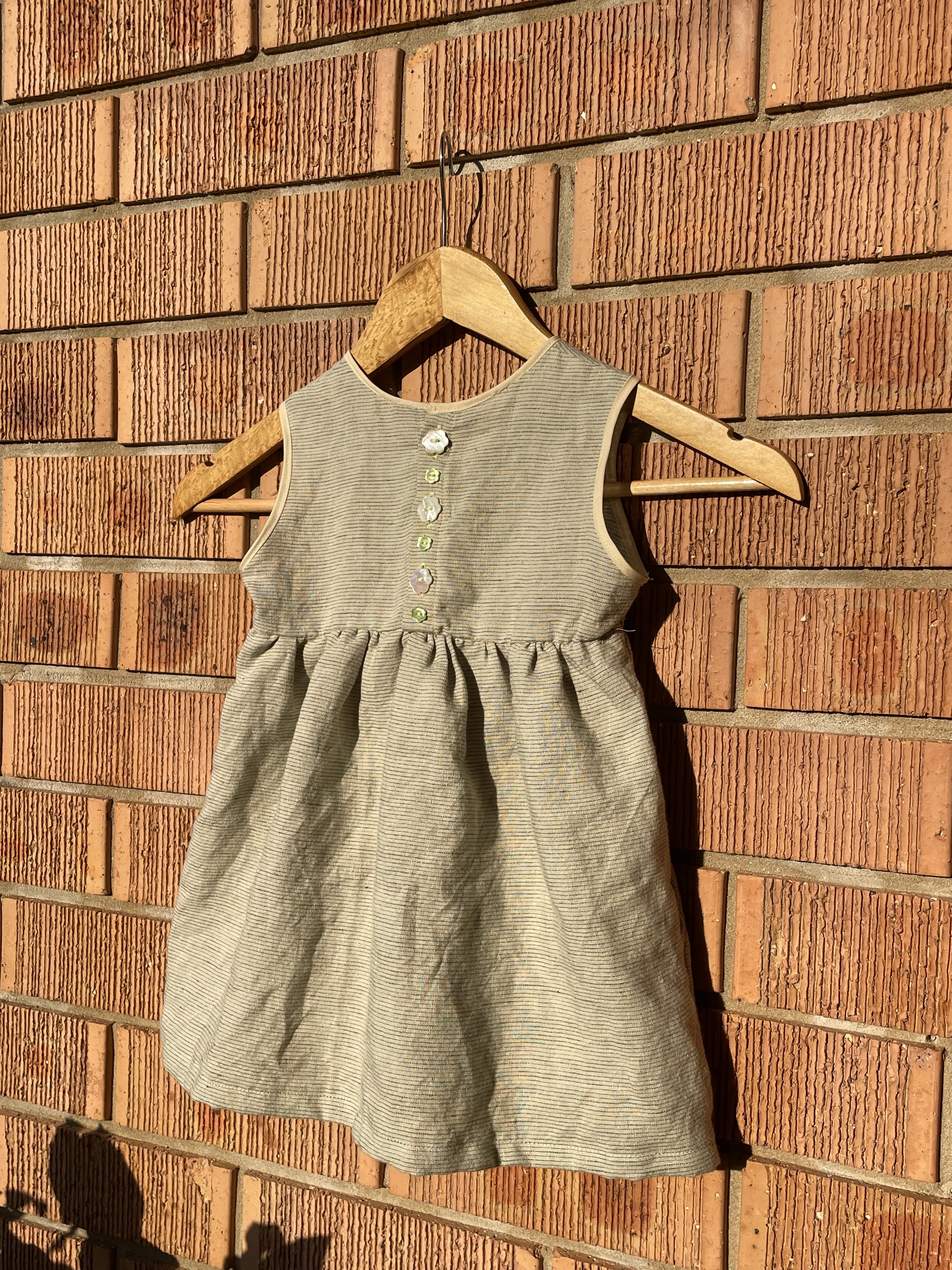 Dress against a brick wall in the sunshine 