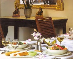 Table at Promenade, adorned with a starter, wine and flowers.