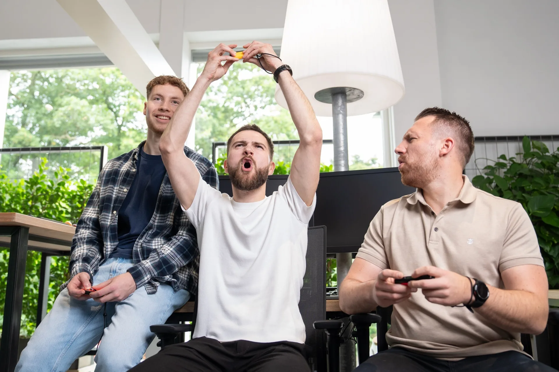 Juichende collega's die een videogame spelen