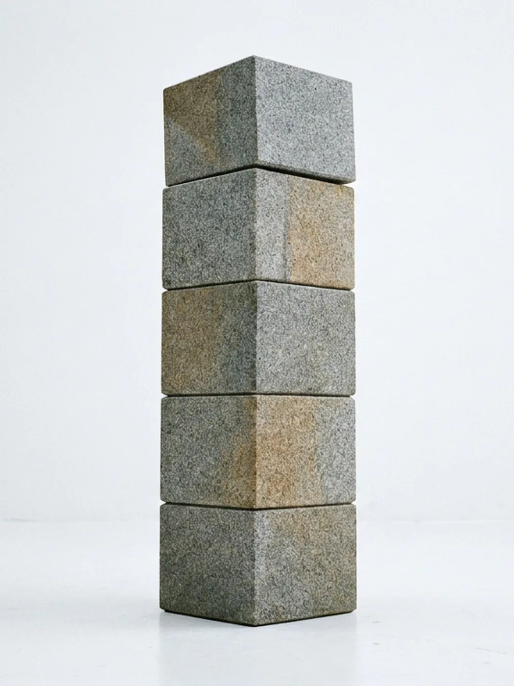 Stack of five grey stone bricks