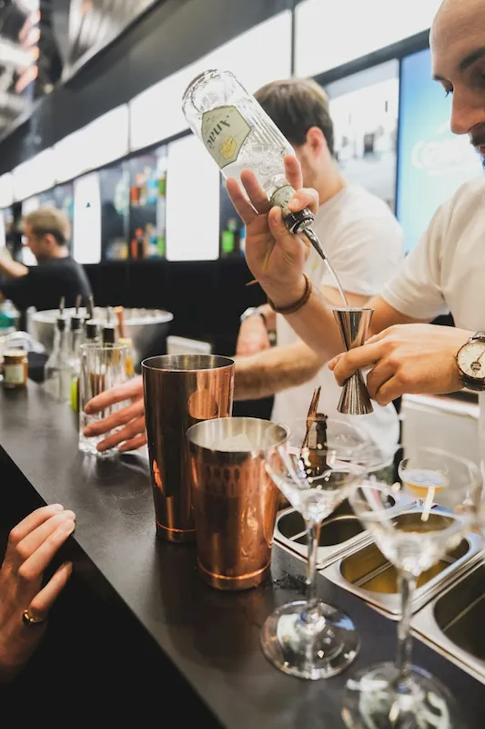 Bartender measuring liquor in a jigger