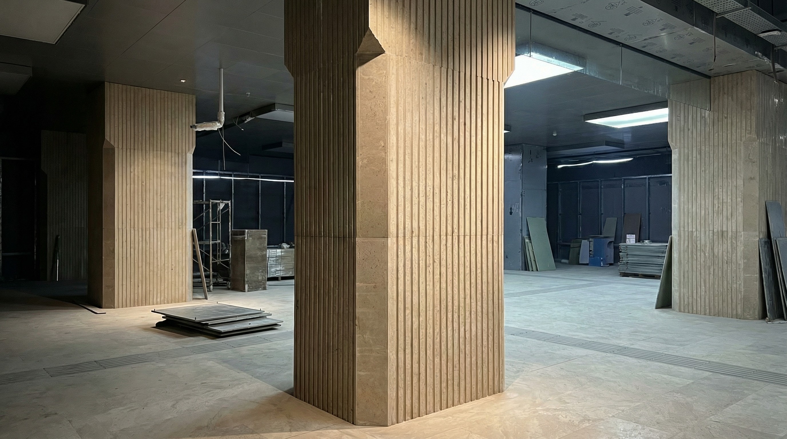 Large-scale fluted stone columns installed in a subway station interior by NOVA STONE.