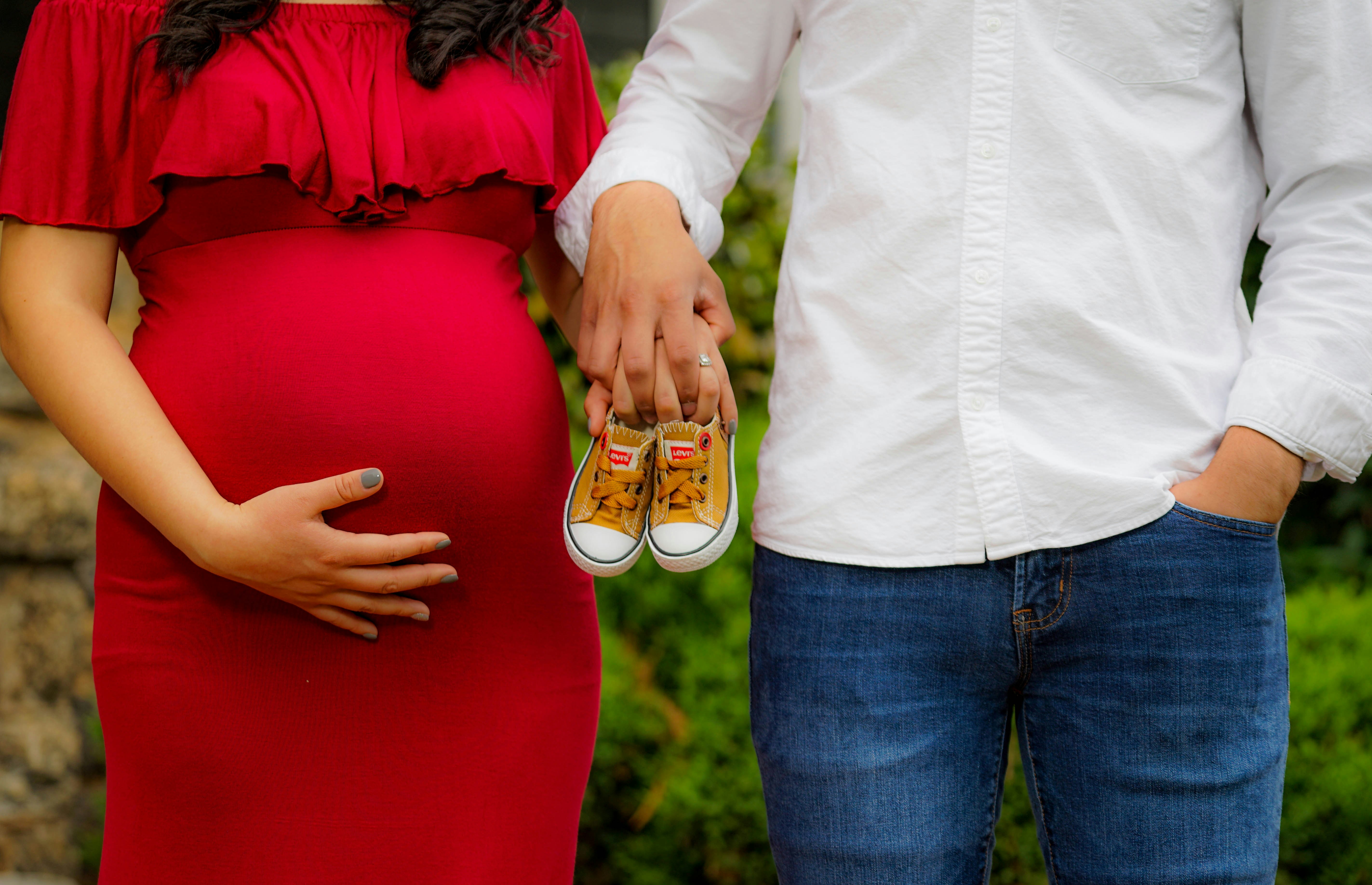 pregnant woman with her husband - Fall Baby Shower Outfits