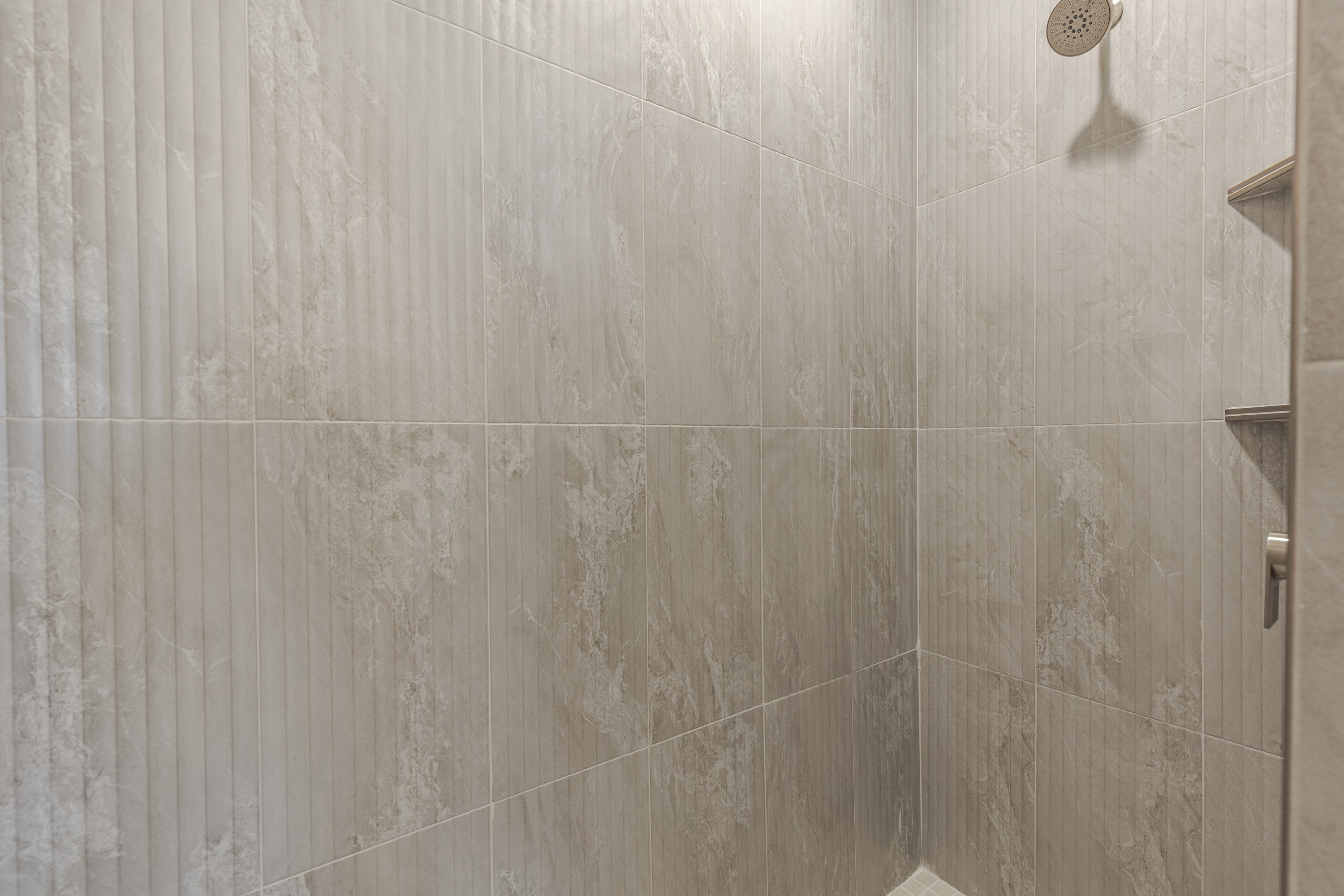 Detail of tile in the master bathroom of the Painted Sands twin home in Hurricane, Utah highlighting clean, modern finishes.