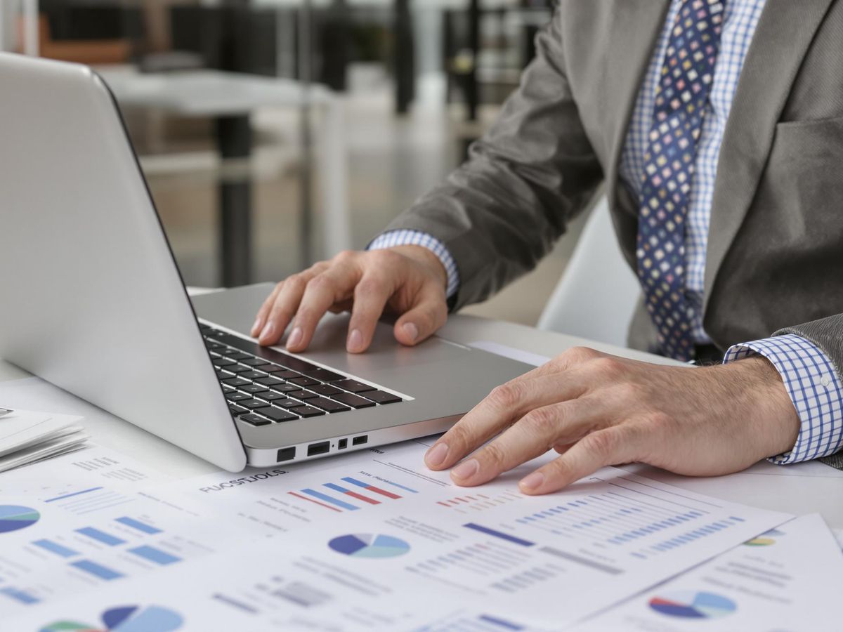 Business professional reviewing documents in a modern office.