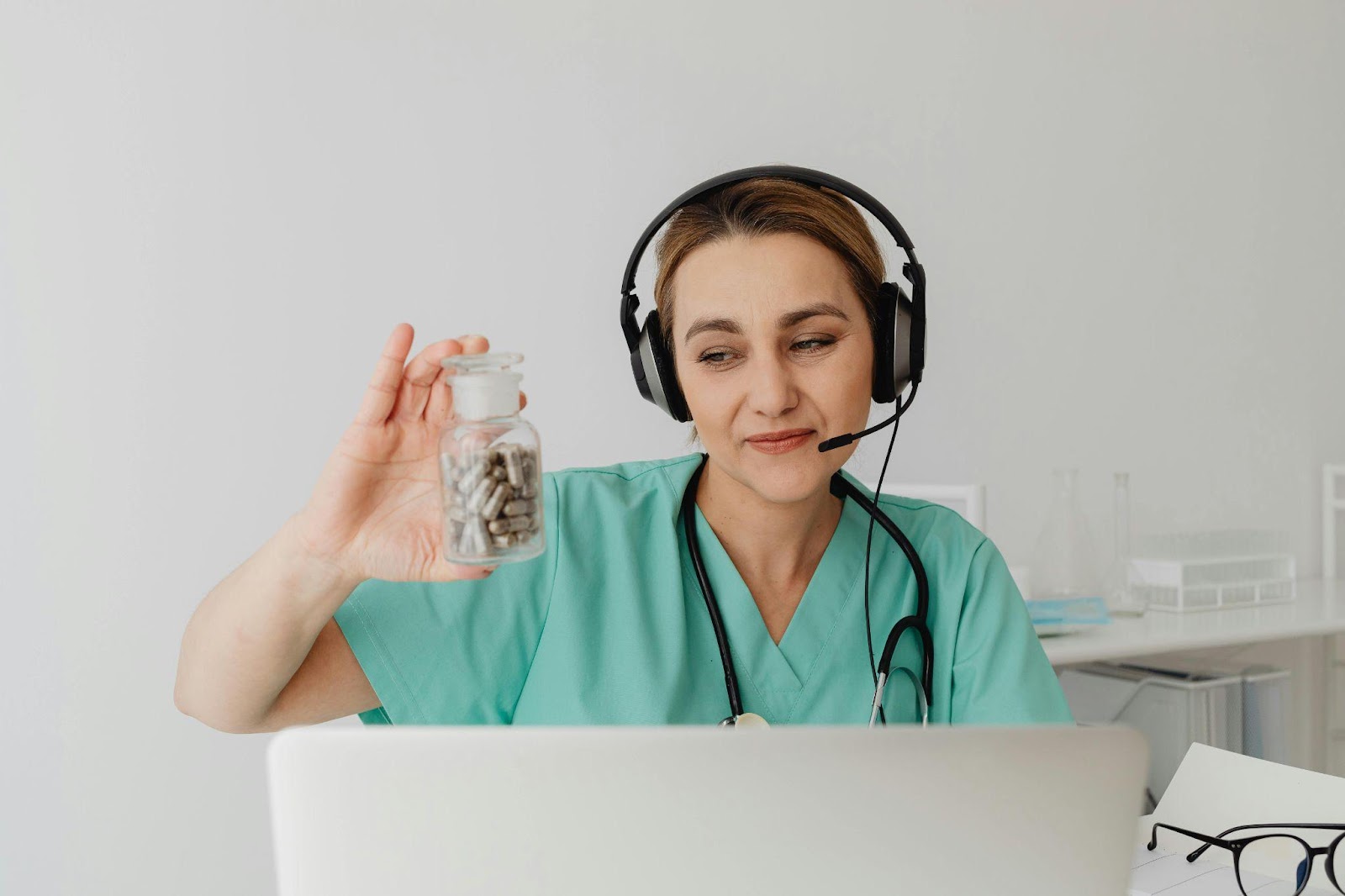  A doctor shows a bottle of pills on a video call.