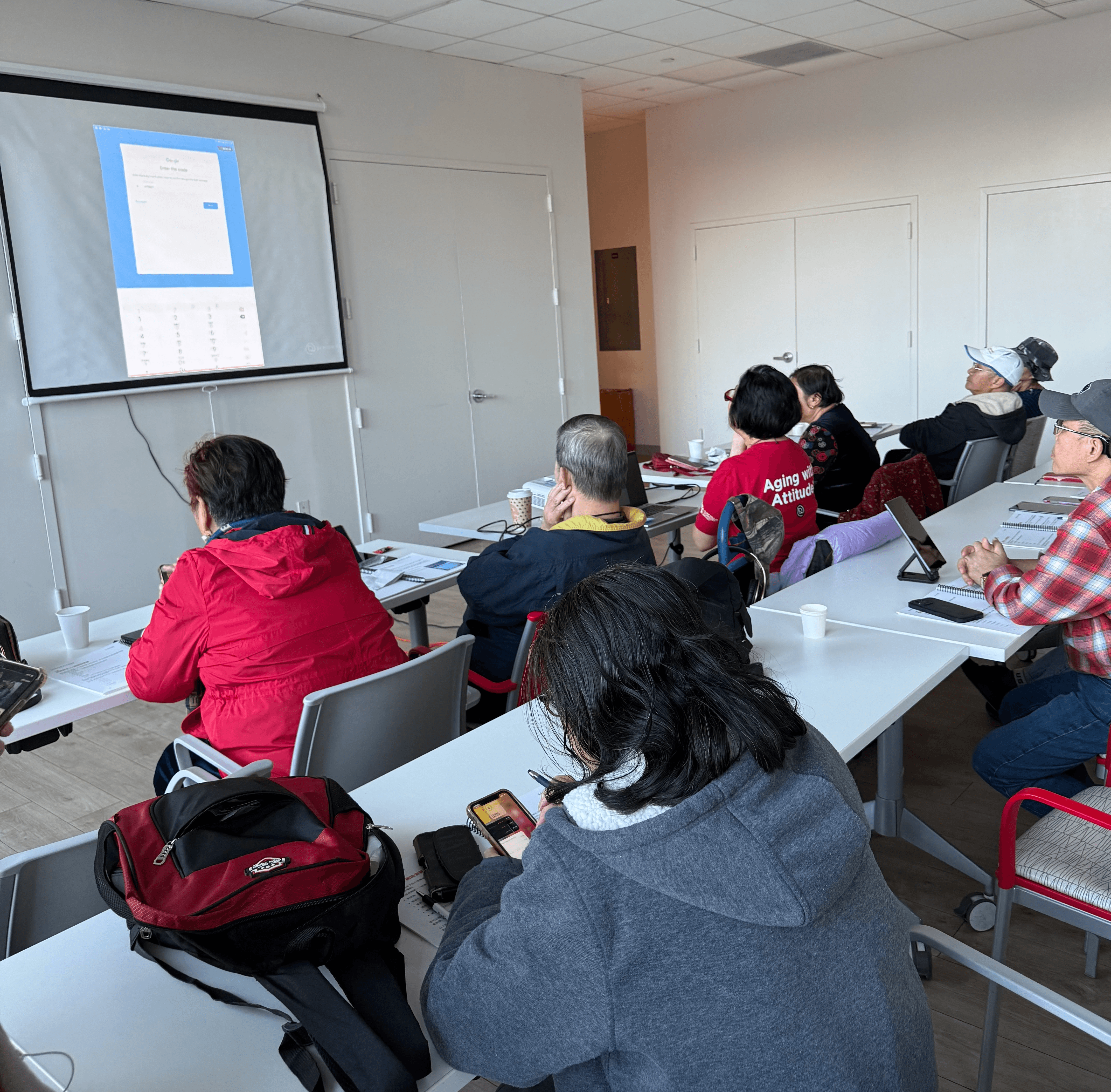 Older Adult participants attend a class lecture on computer essentials.