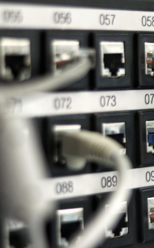 Professional woman in a suit standing in an office setting.