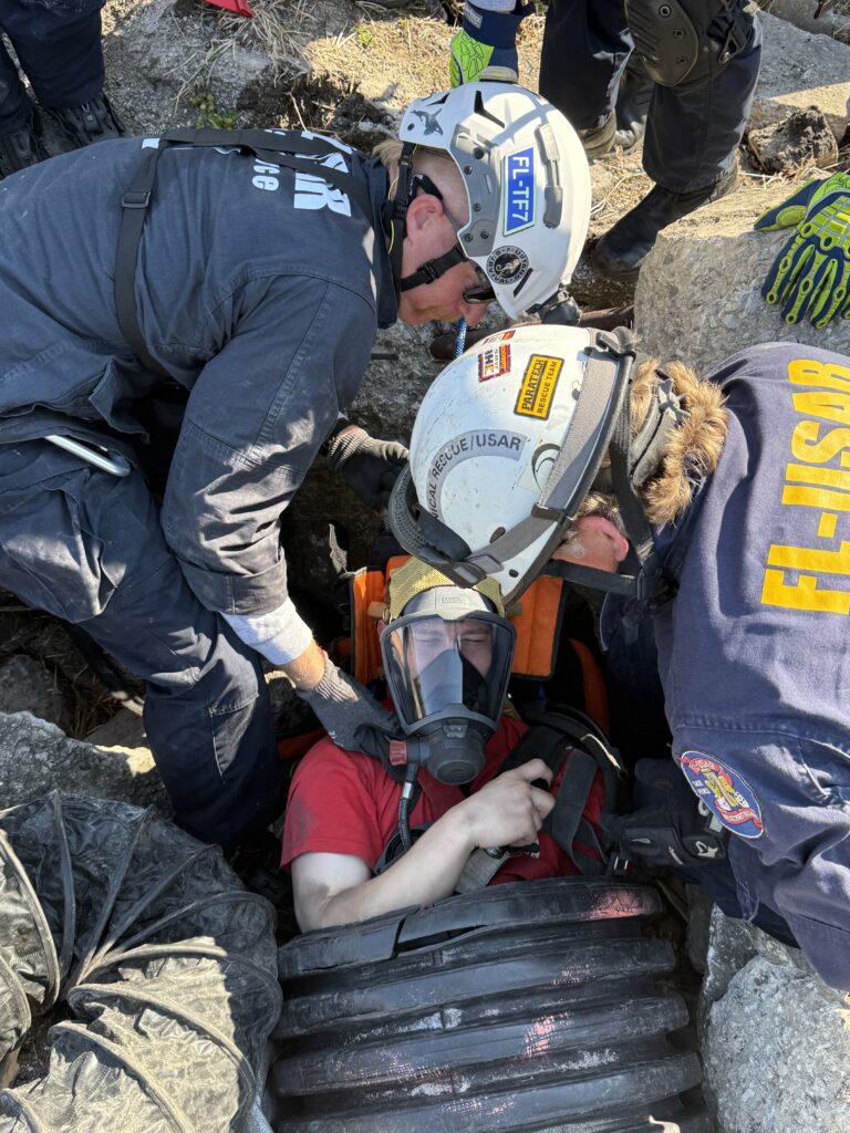 Florida Task Force 7 extracting a victim from a debris pile at Fire Academy of the South in Jacksonville.