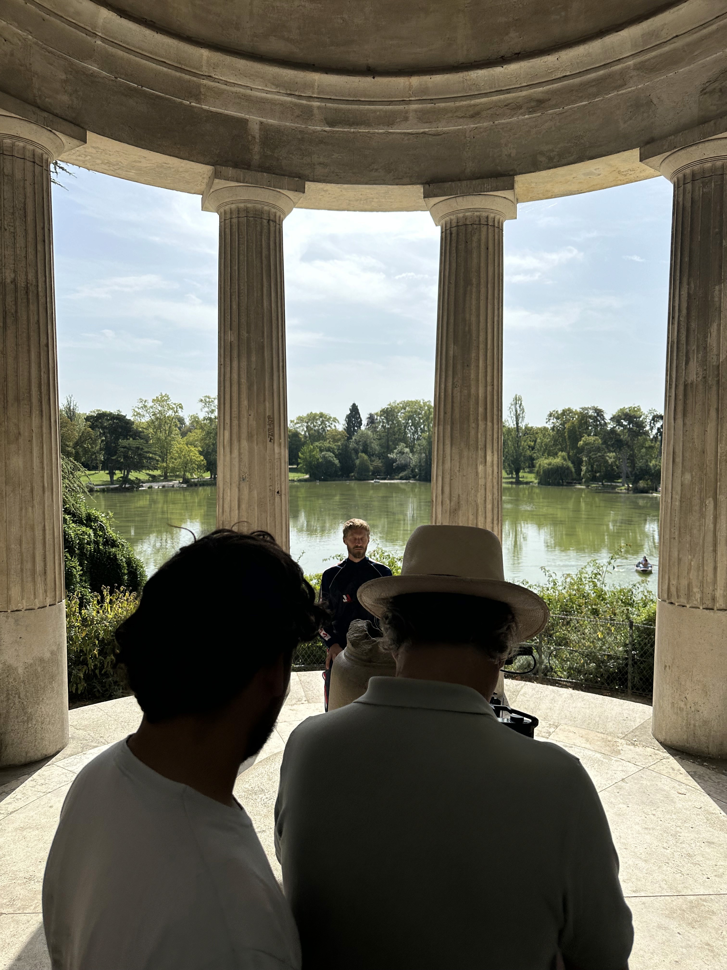Woman in pink leather jacket crouching outdoors at night