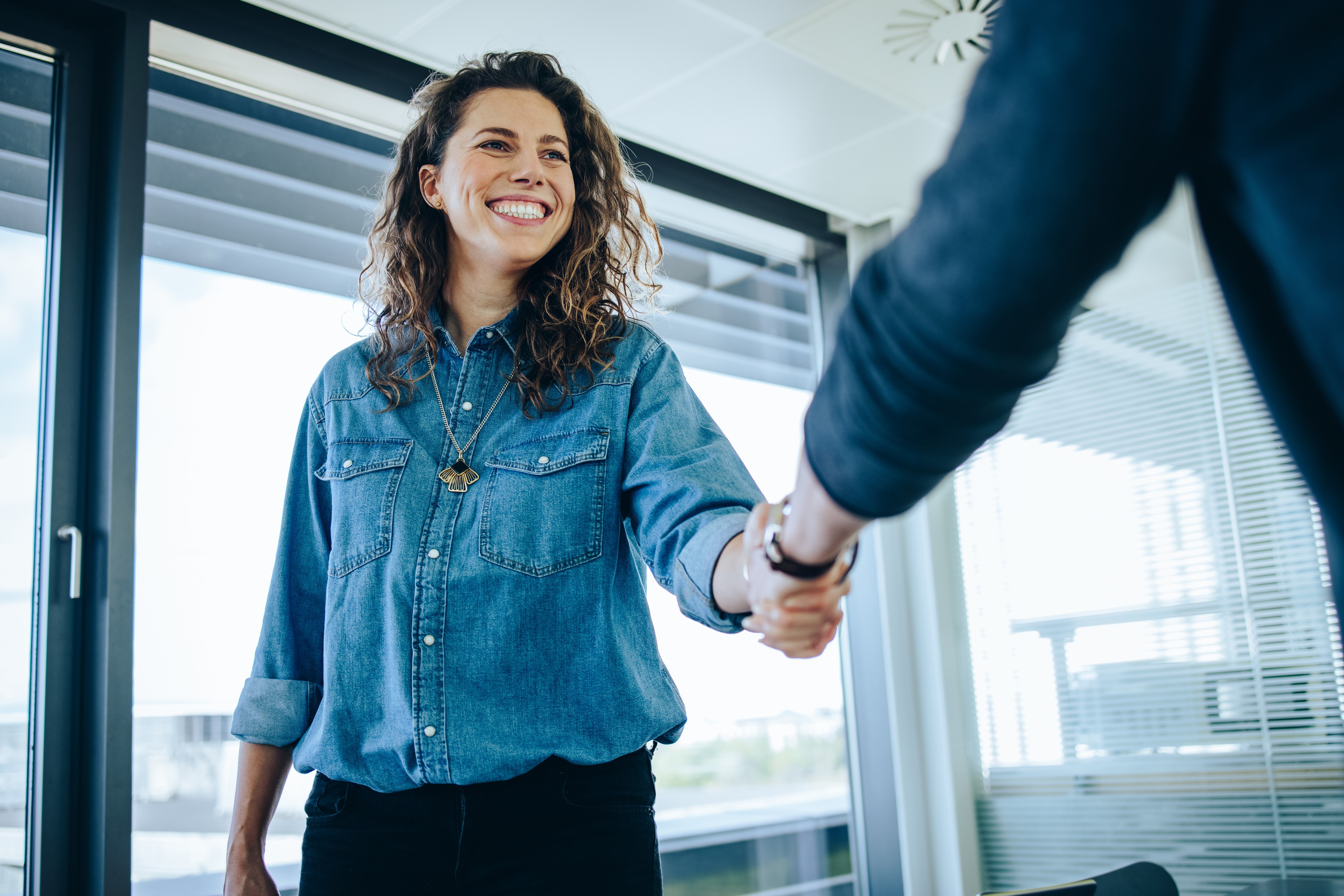 A woman happy whilst creating a business partnership.