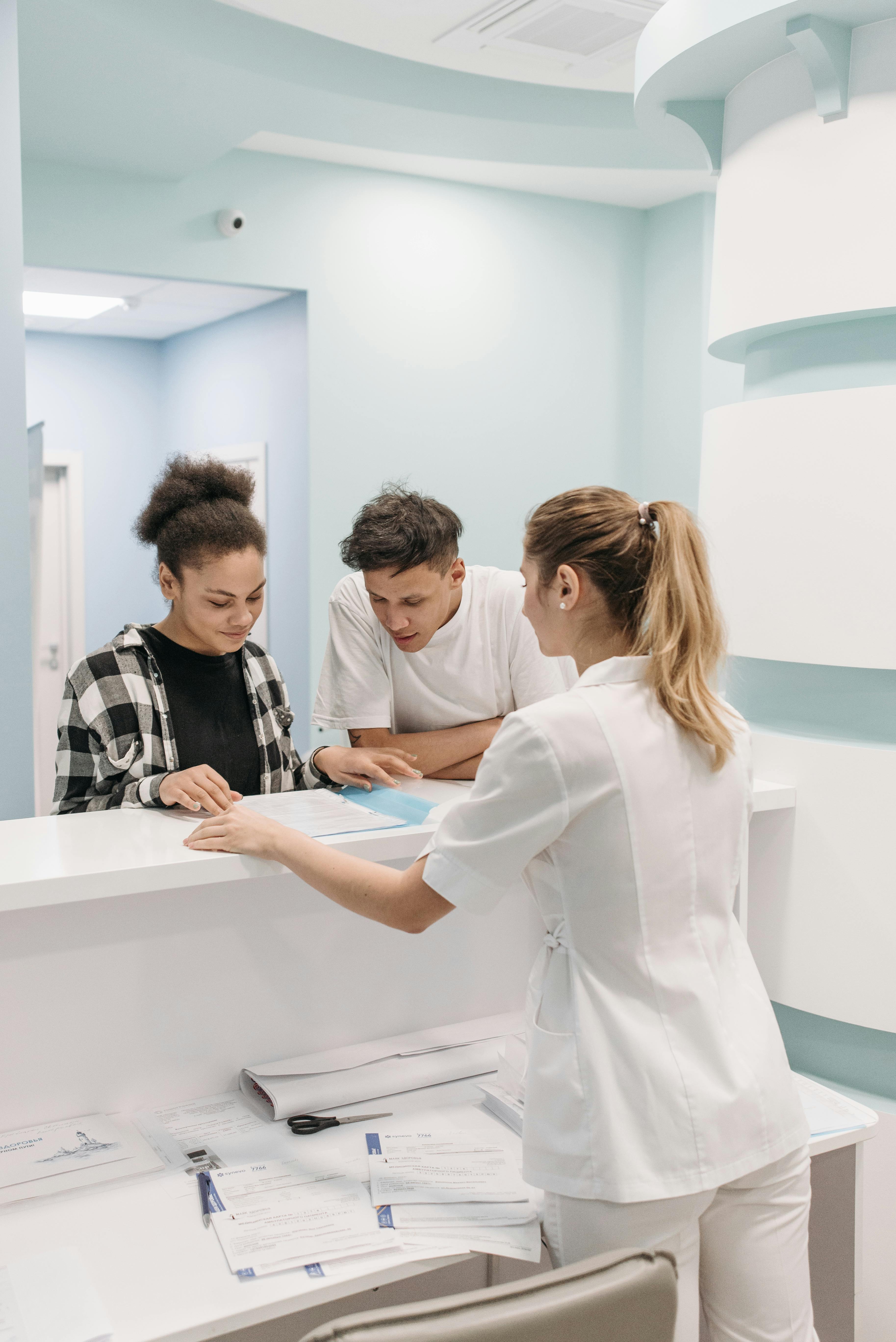 woman at dental reception desk helping customers