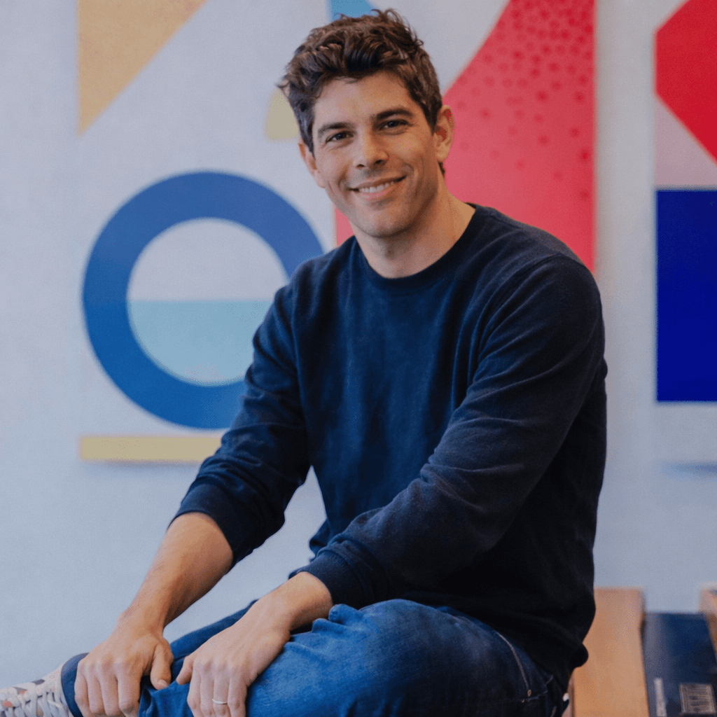 Black and white portrait of a smiling person with curly hair