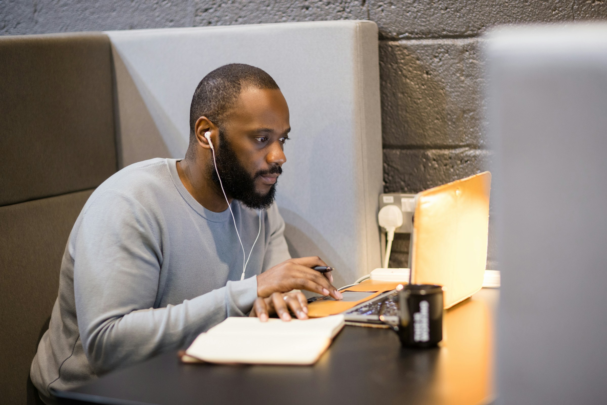 man looking at his computer - How To Find Academic Sources