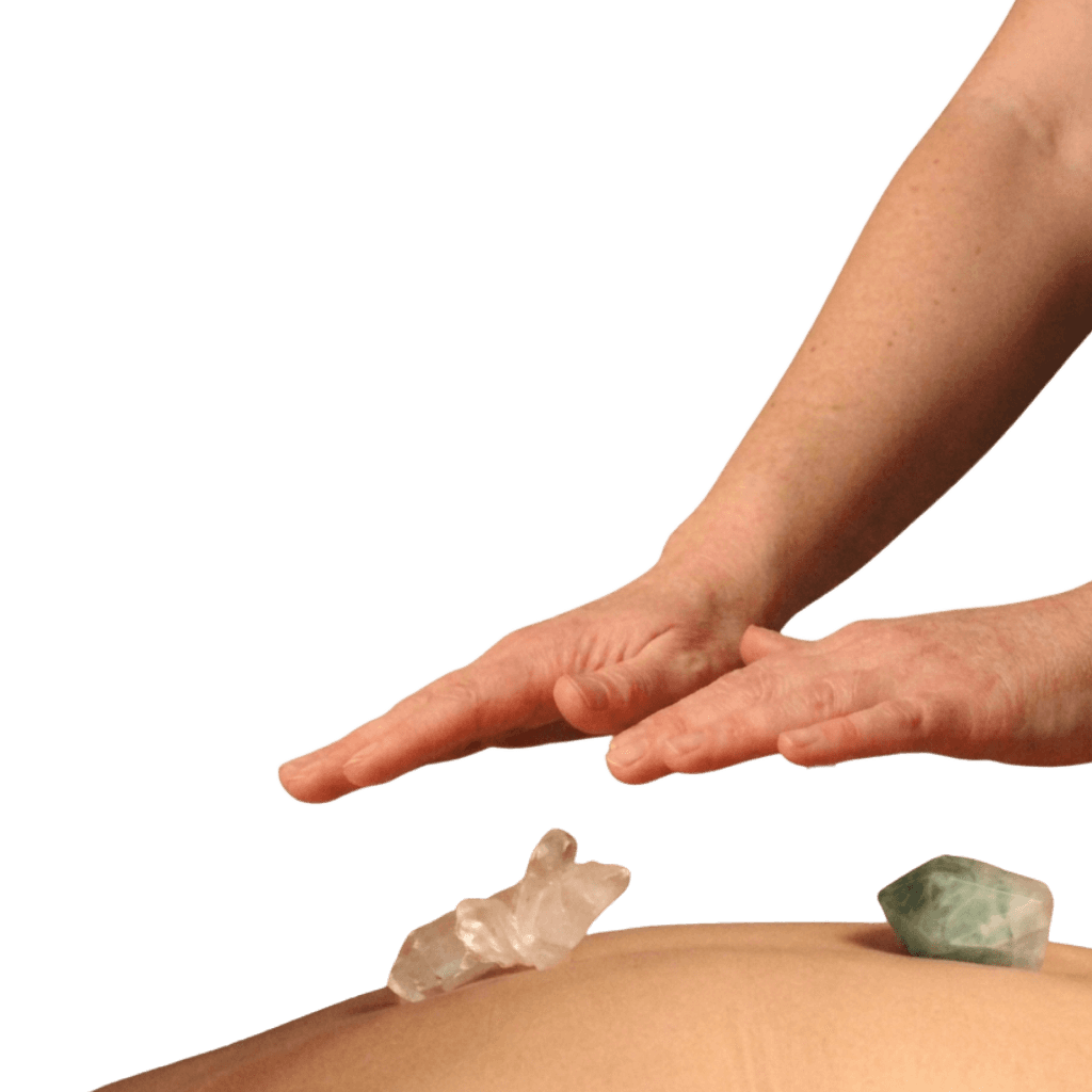 Reiki hands on a patient's back with two healing crystals