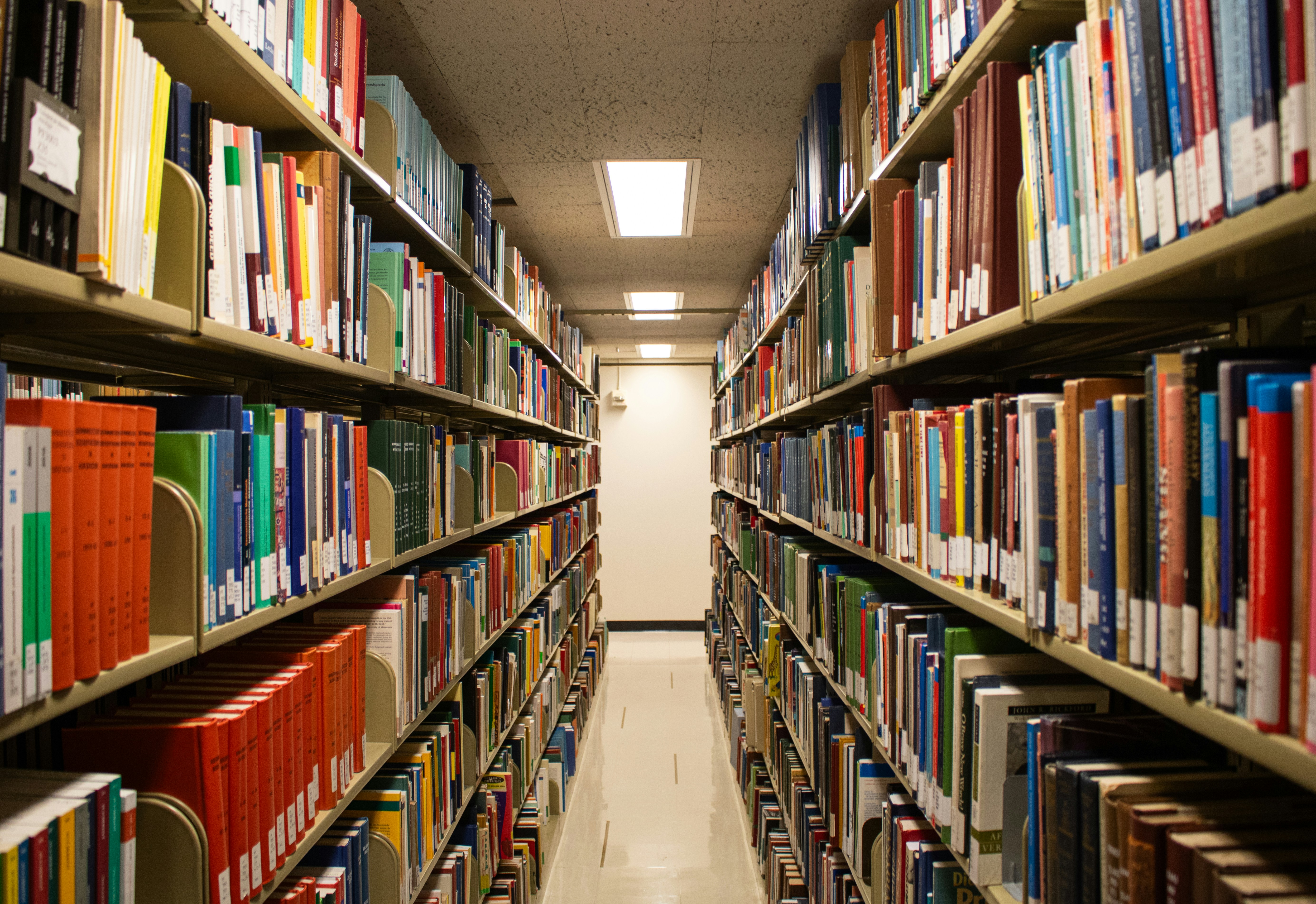 Rows of books fill a library aisle.