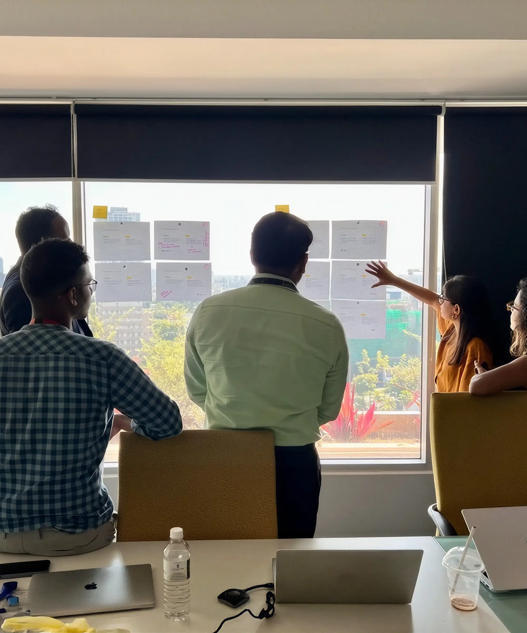 UX research team reviewing findings and mapping user insights on a wall.