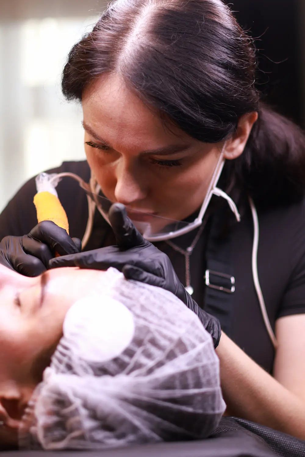 PMU specialist examining client's work closely